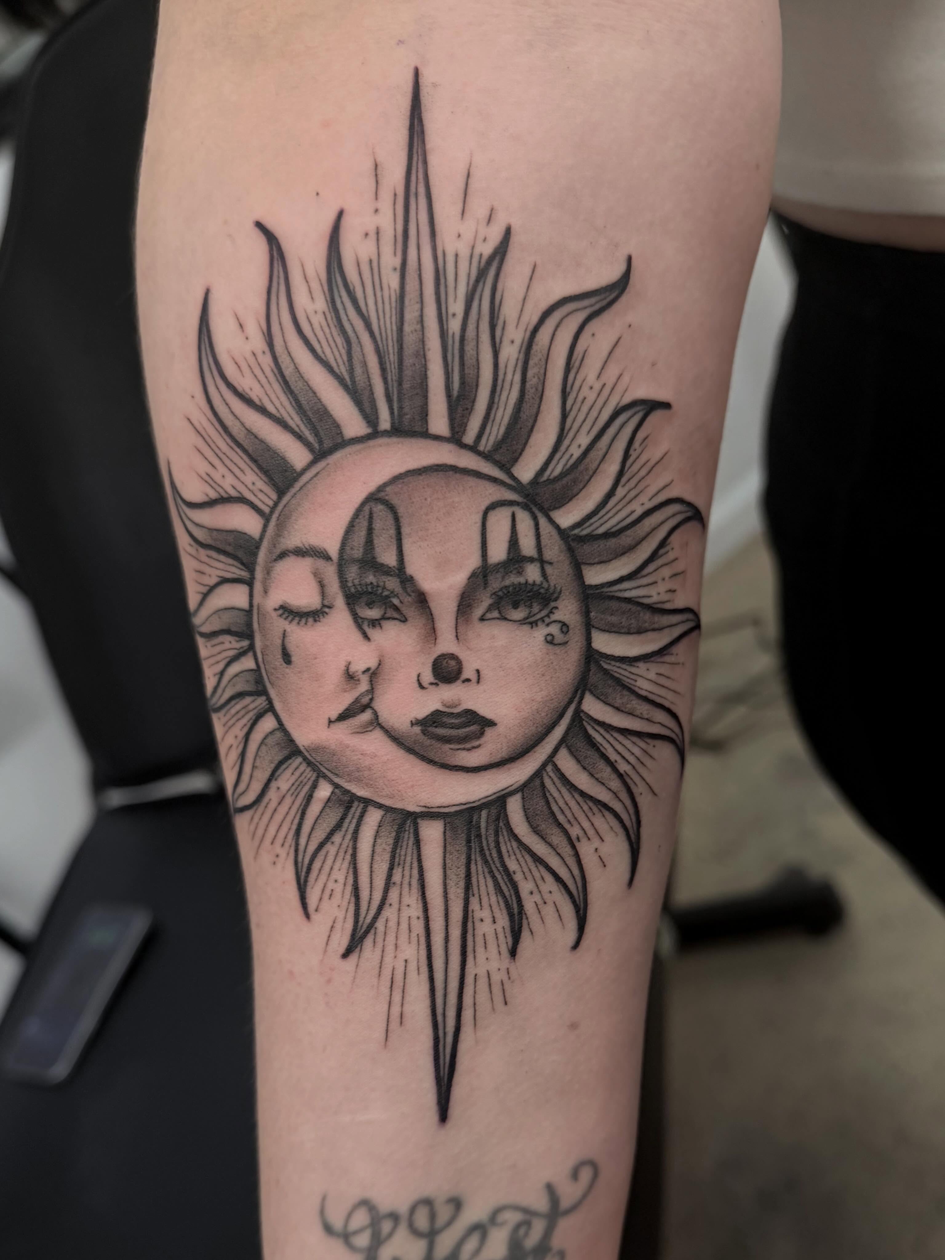 Sun and moon faces realism tattoo on the forearm by H.G