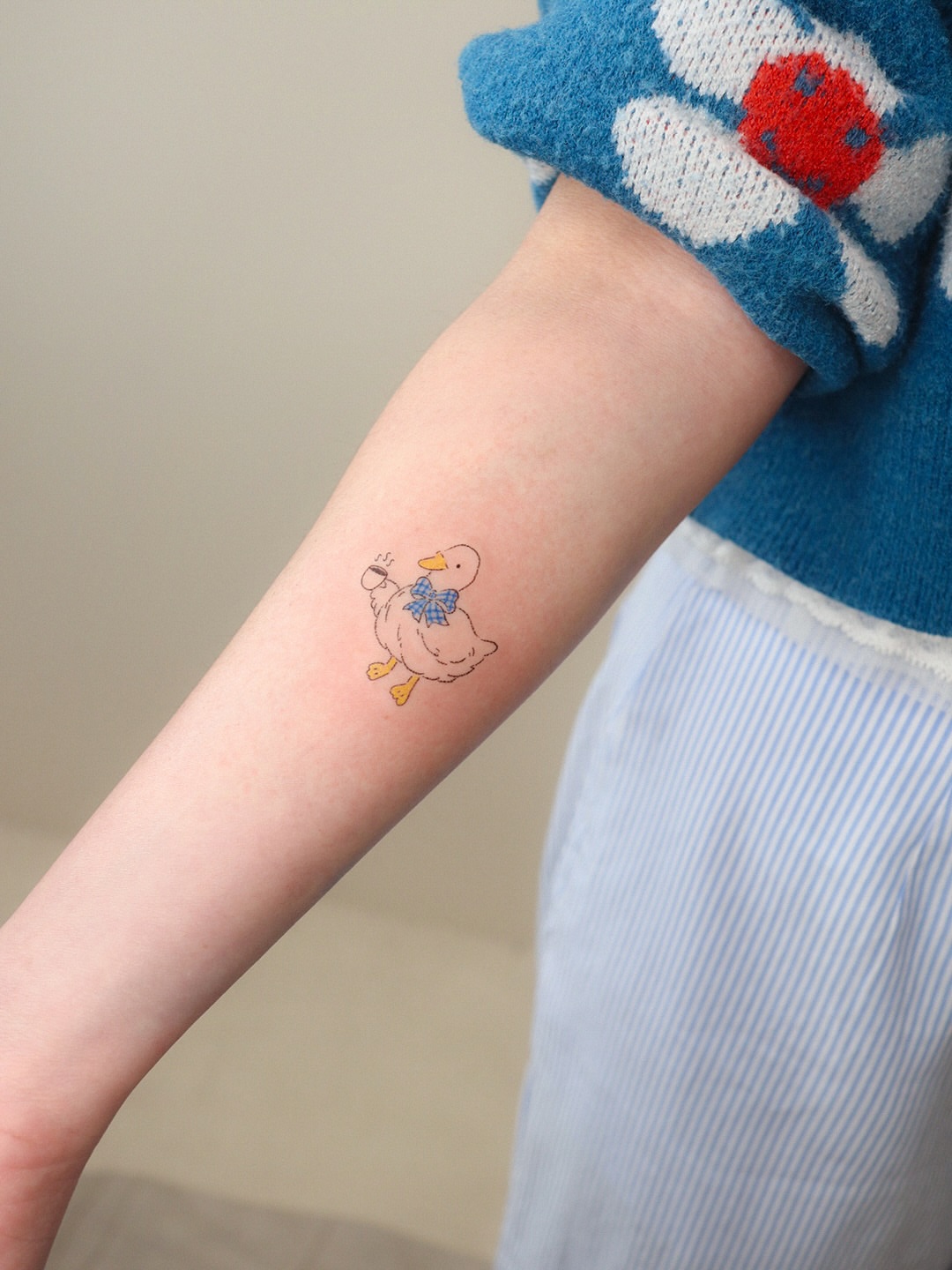 Duck illustrative tattoo on the forearm by Bay