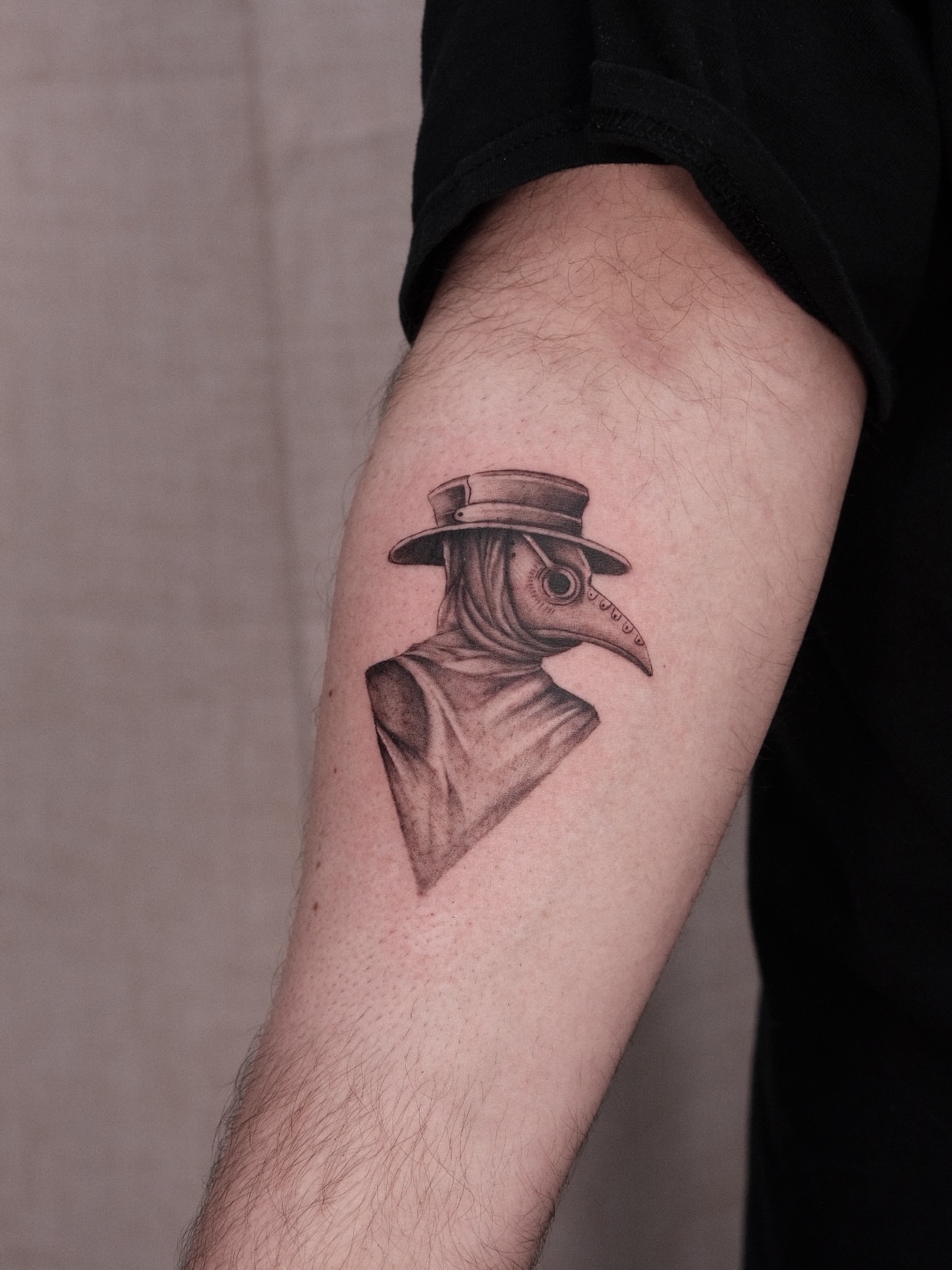 Plague doctor black and grey tattoo on the forearm by Houston Tattoo Artist GoldenK