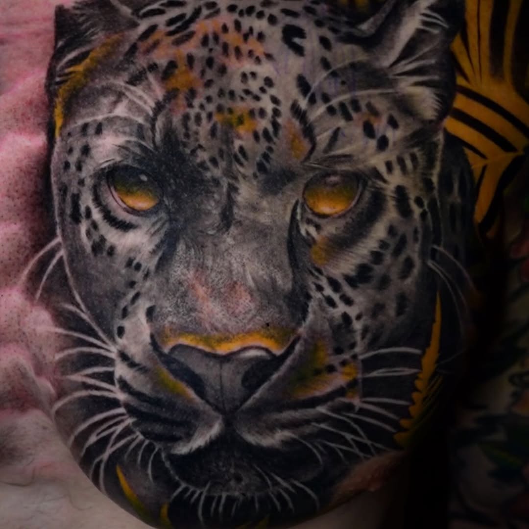 Leopard portrait realism tattoo on the torso by Erick Satchell II