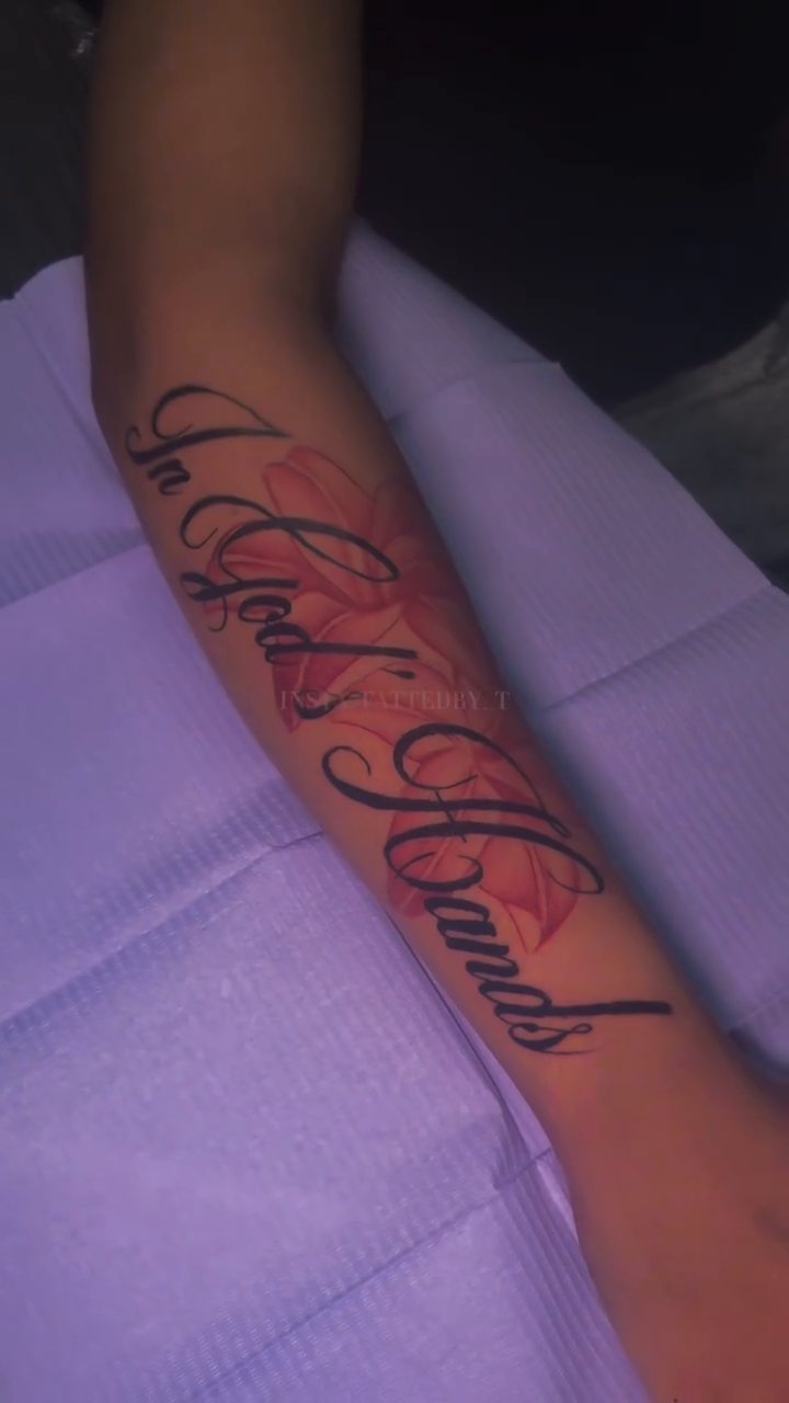In God's Hands tattoo with roses lettering tattoo on the forearm by Female Cleveland Tat Artist ๐