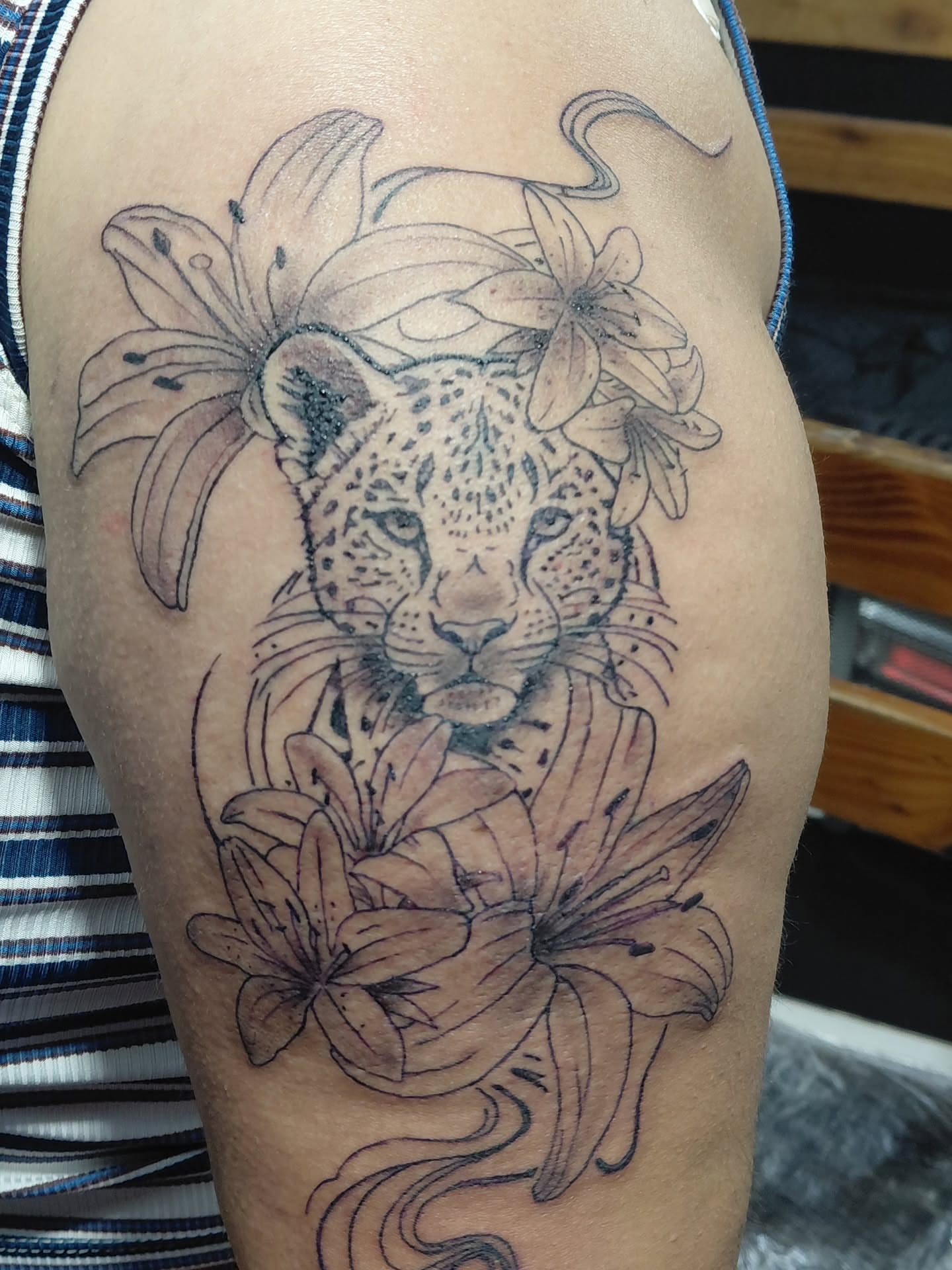 Leopard and lilies realism tattoo on the thigh by Jose Rodriguez