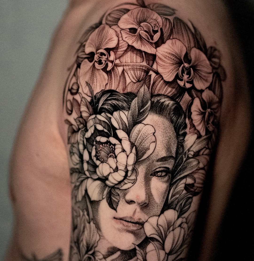 Woman's portrait with flowers realism tattoo on the forearm by Mark Vata
