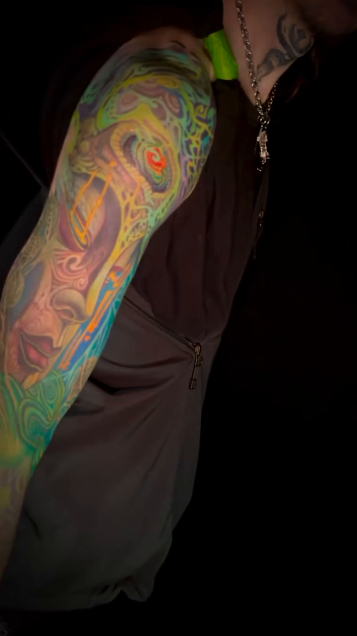 Abstract colorful sleeve tattoo surrealism tattoo on the upper arm by David goldstein