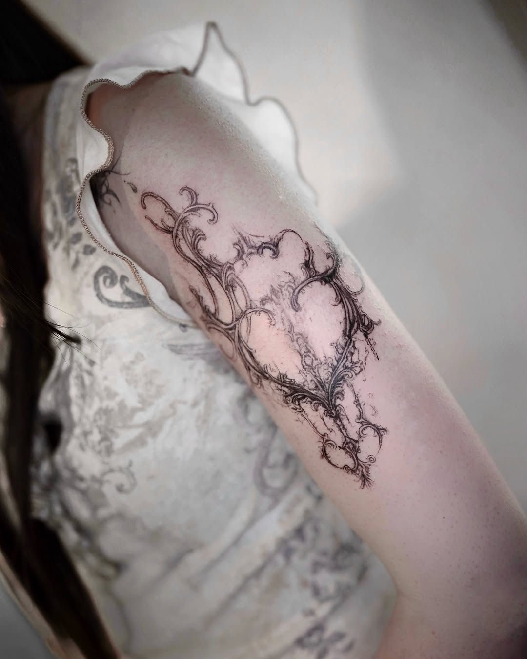 Ornamental frame with floral elements cyber sigilism tattoo on the forearm by @ashencoil