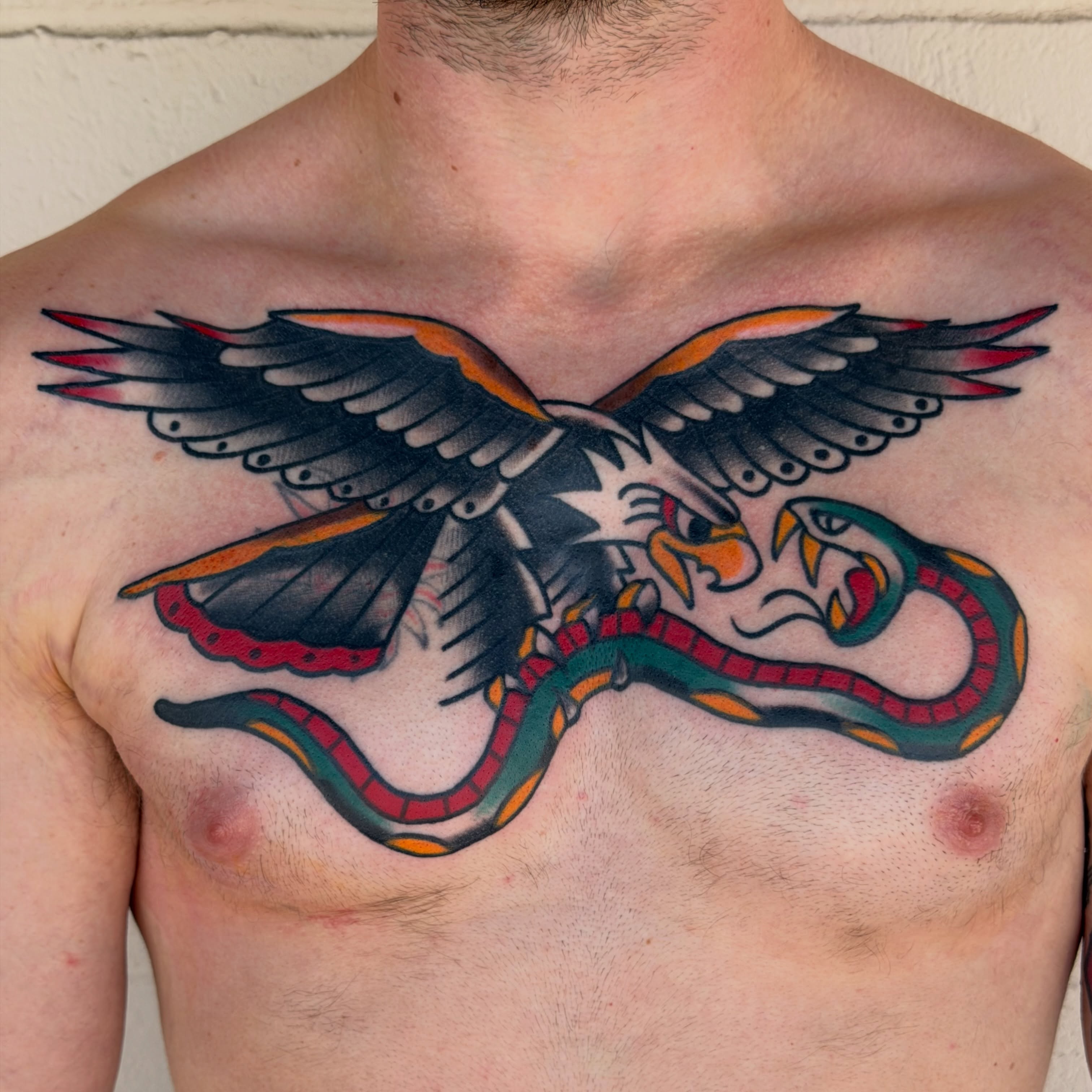 Eagle and snake American traditional tattoo on the chest by Kyle Dean Traditional Tattoo Artist