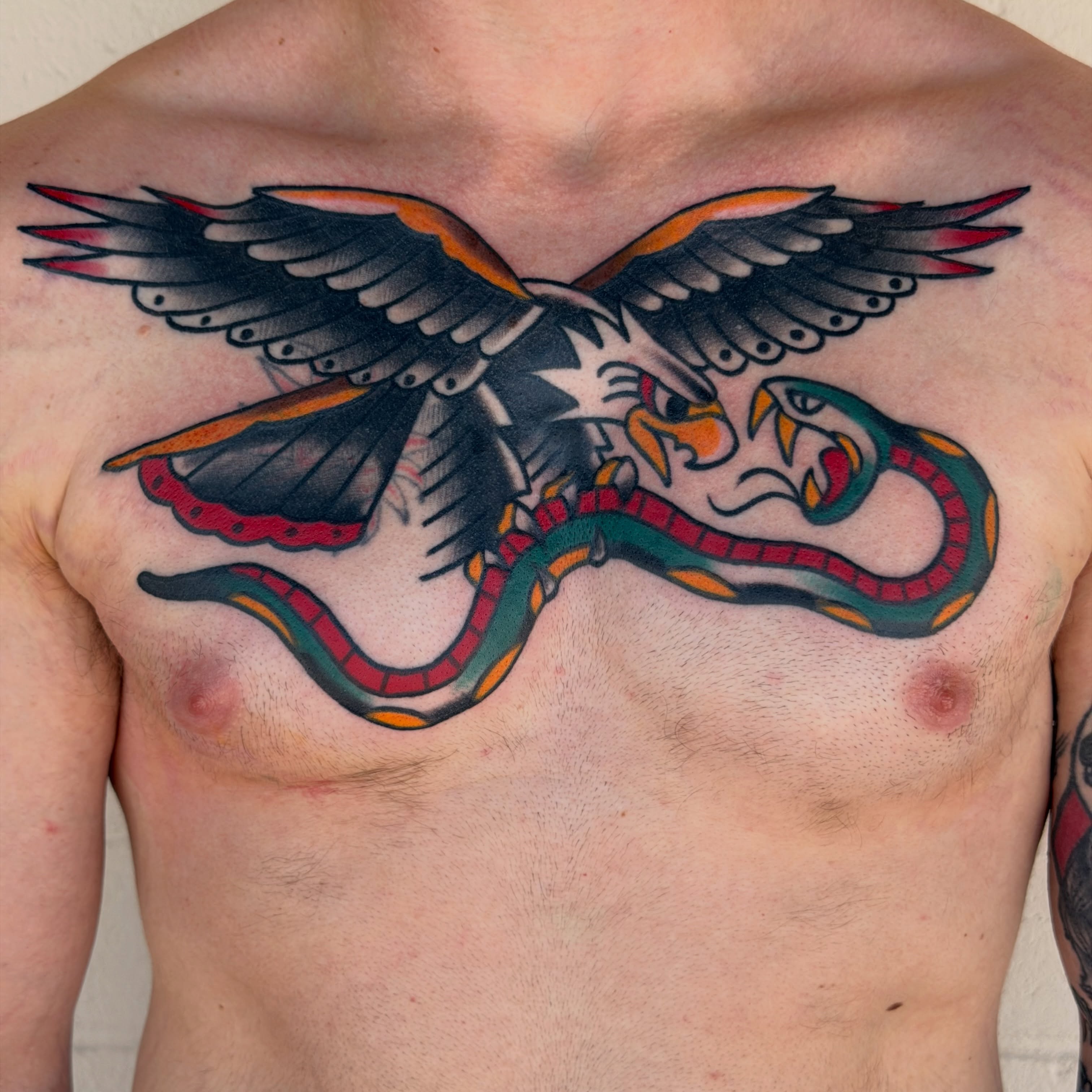 Eagle and snake American traditional tattoo on the chest by Kyle Dean Traditional Tattoo Artist