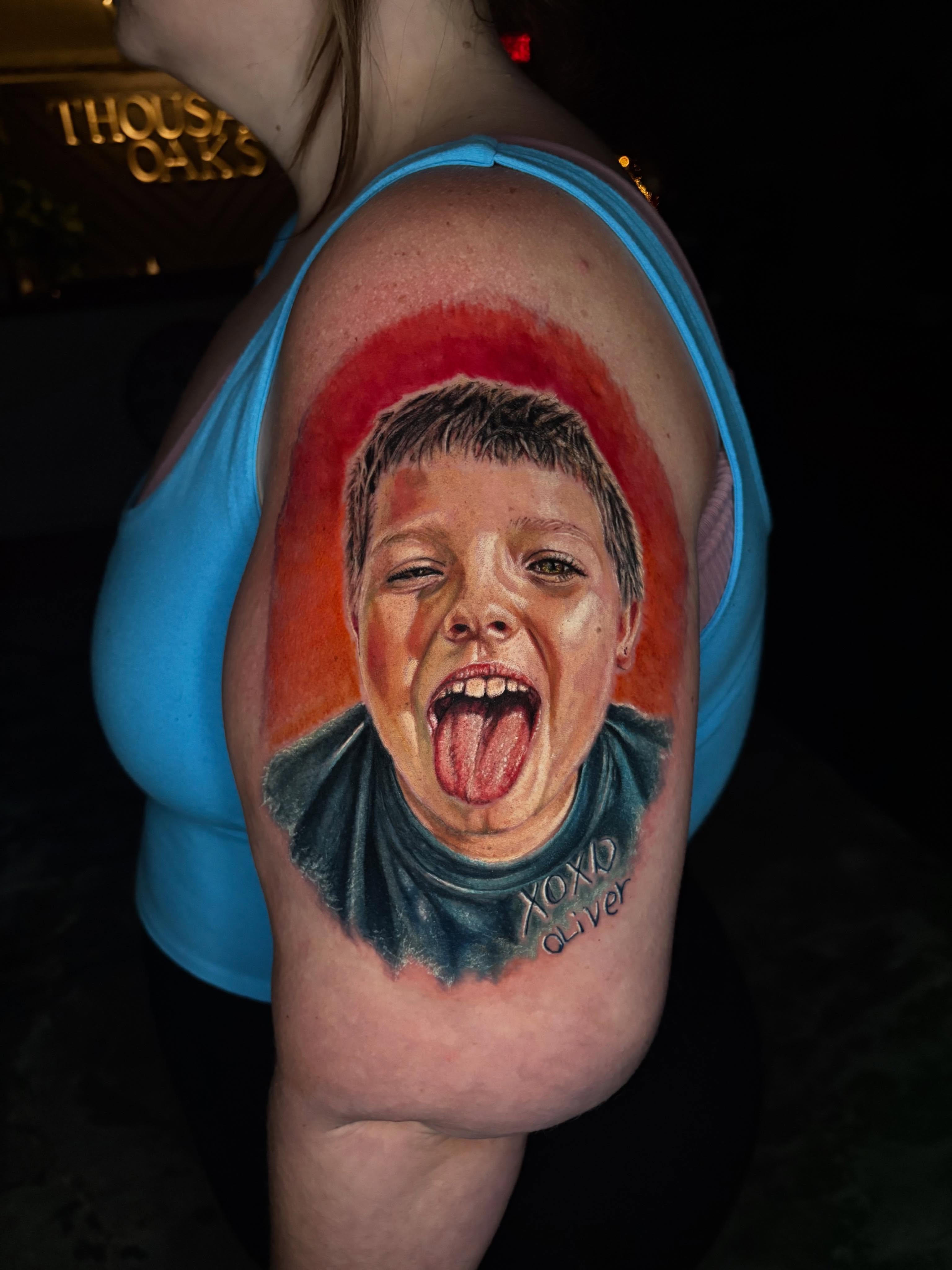 Portrait of a boy neo-traditional tattoo on the shoulder by Jacee Hamilton