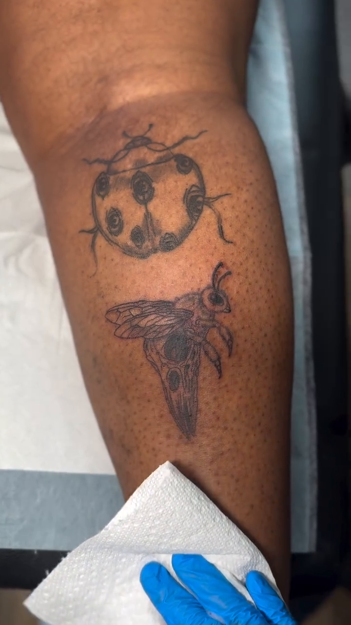A beetle and a ladybug fine line tattoo on the thigh by Charlotte Tattoo Artist💉