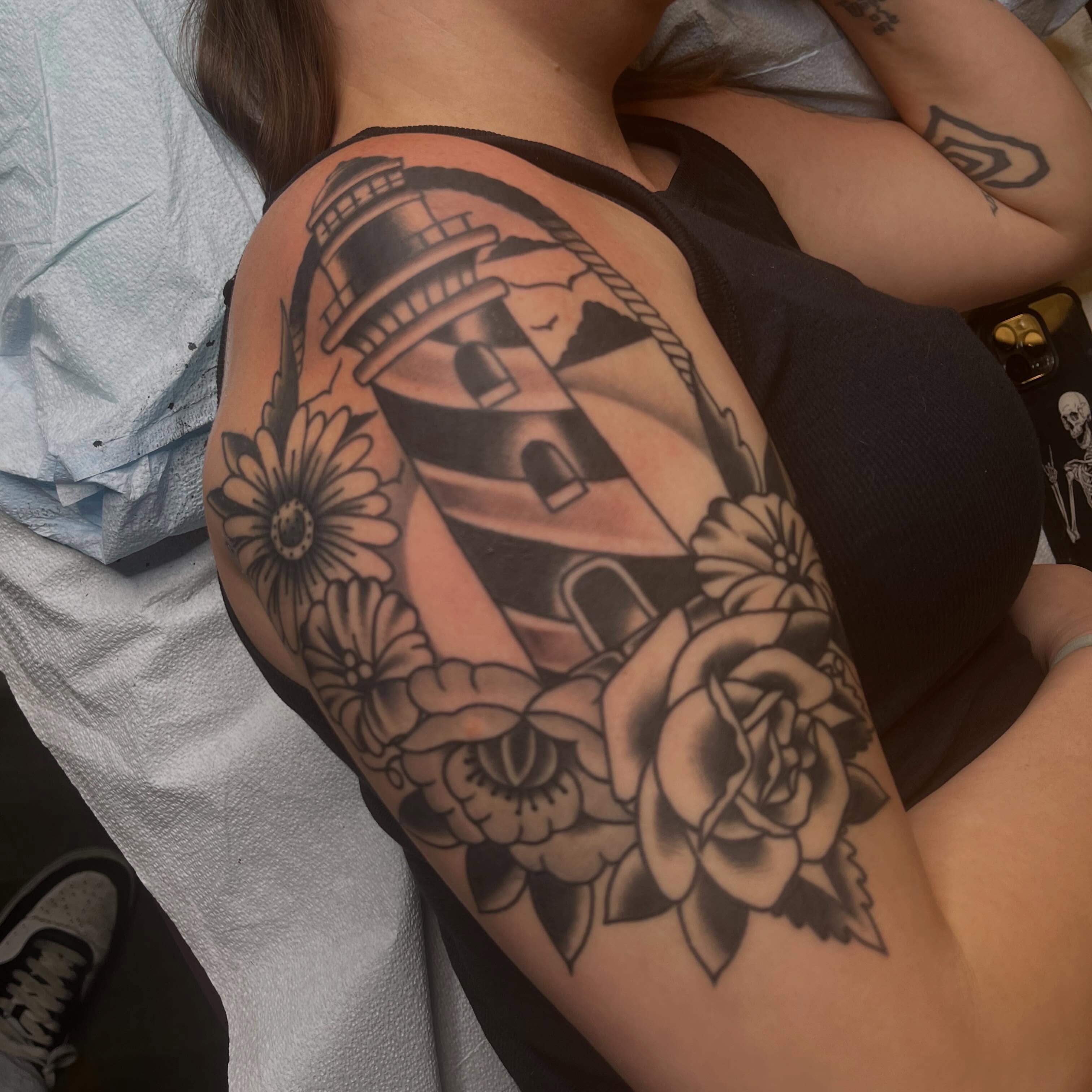 Lighthouse and flowers American traditional tattoo on the shoulder by Alex Ratliff