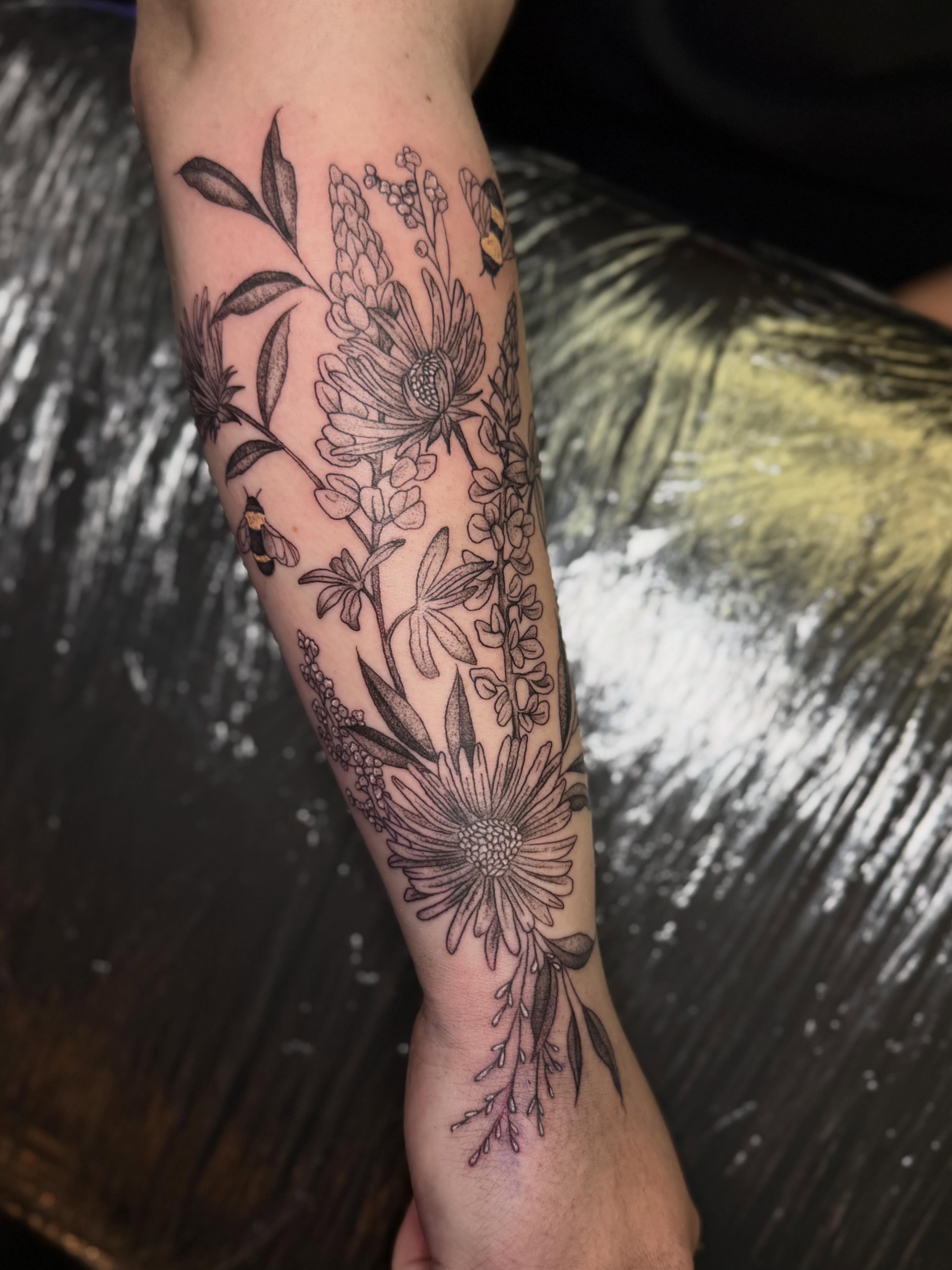 Floral bouquet black and grey tattoo on the forearm by βπ¬π―π’πΆ