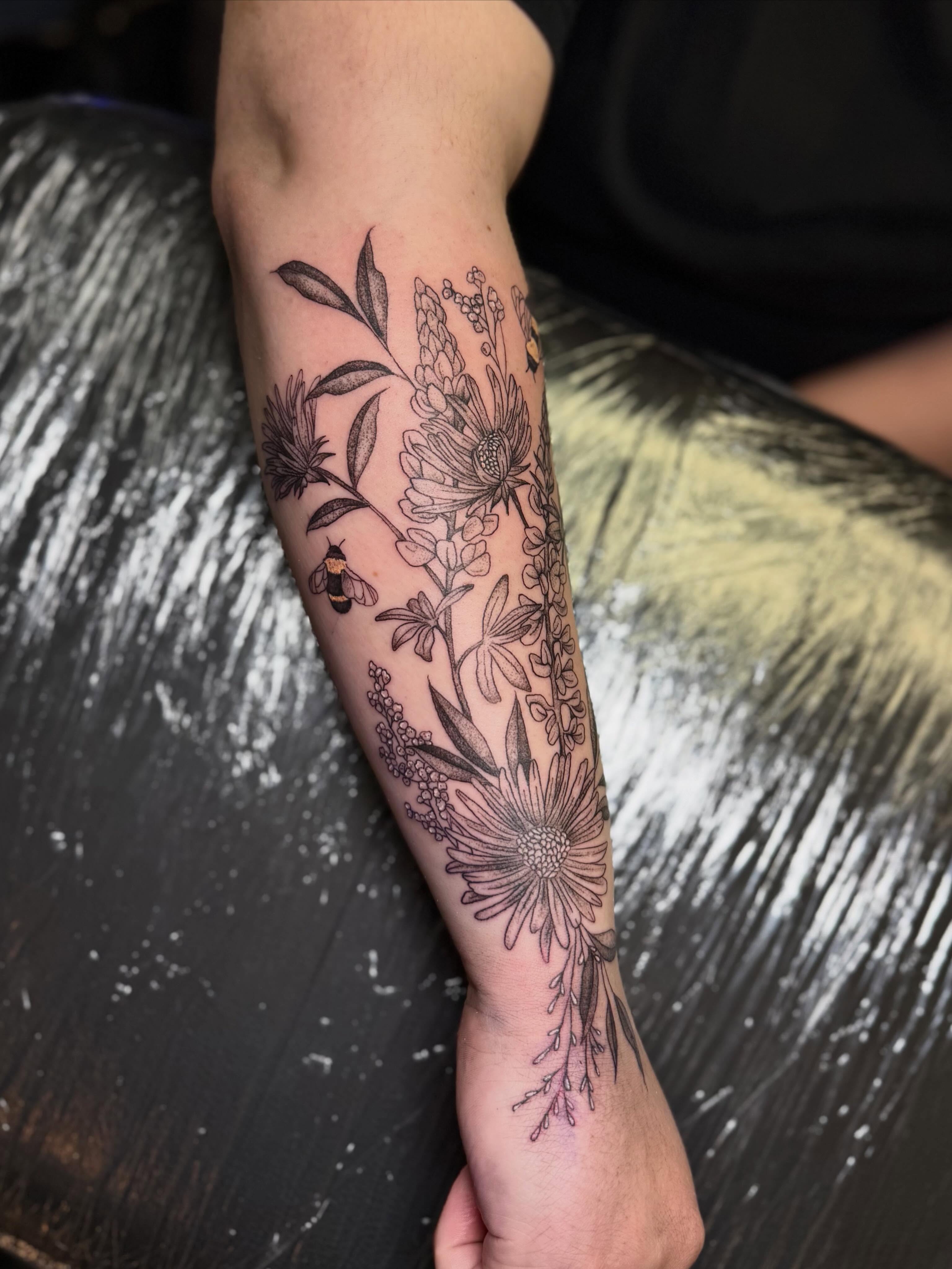 Floral arrangement black and grey tattoo on the forearm by βπ¬π―π’πΆ
