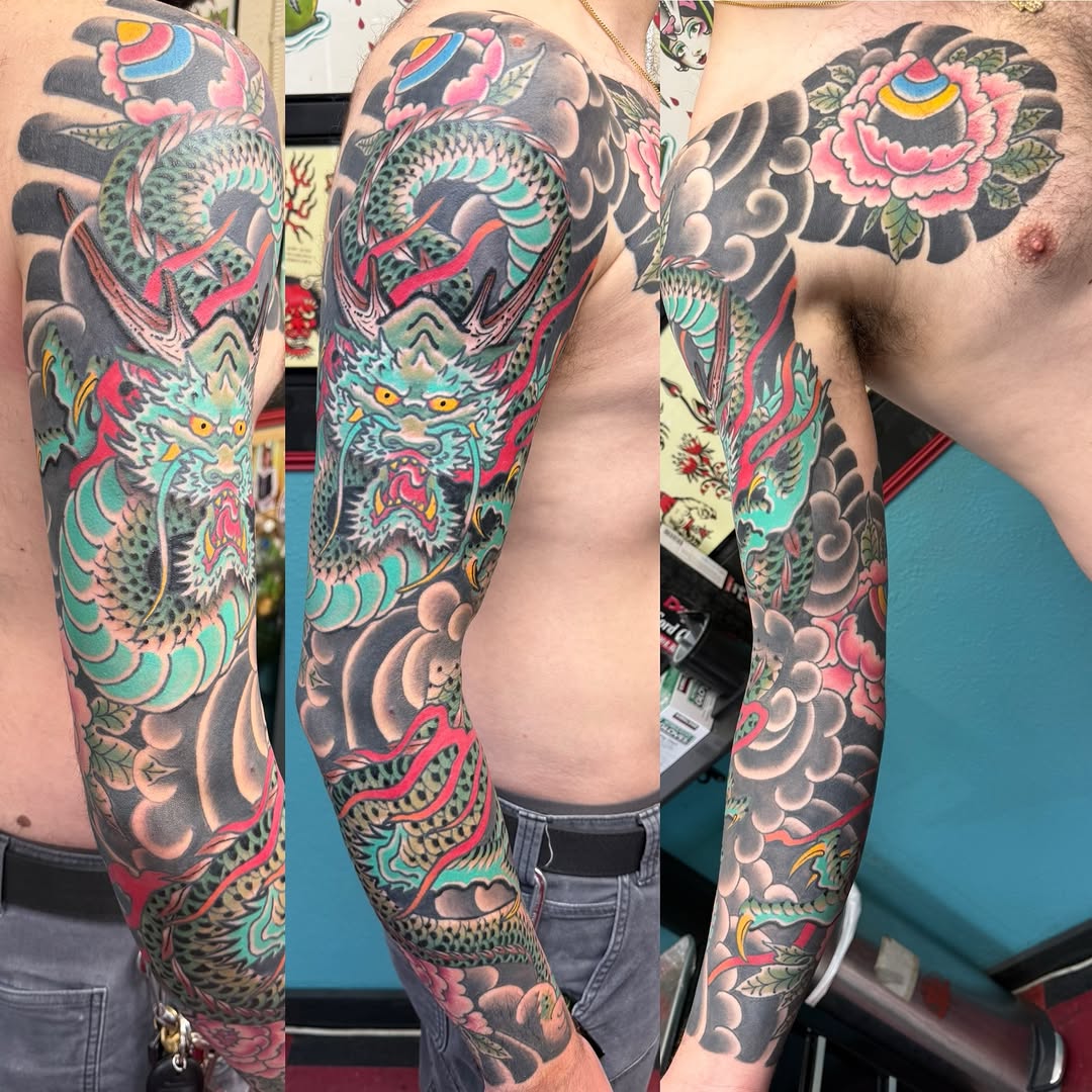 Dragon and peony Japanese tattoo on the upper arm by DemianThompson