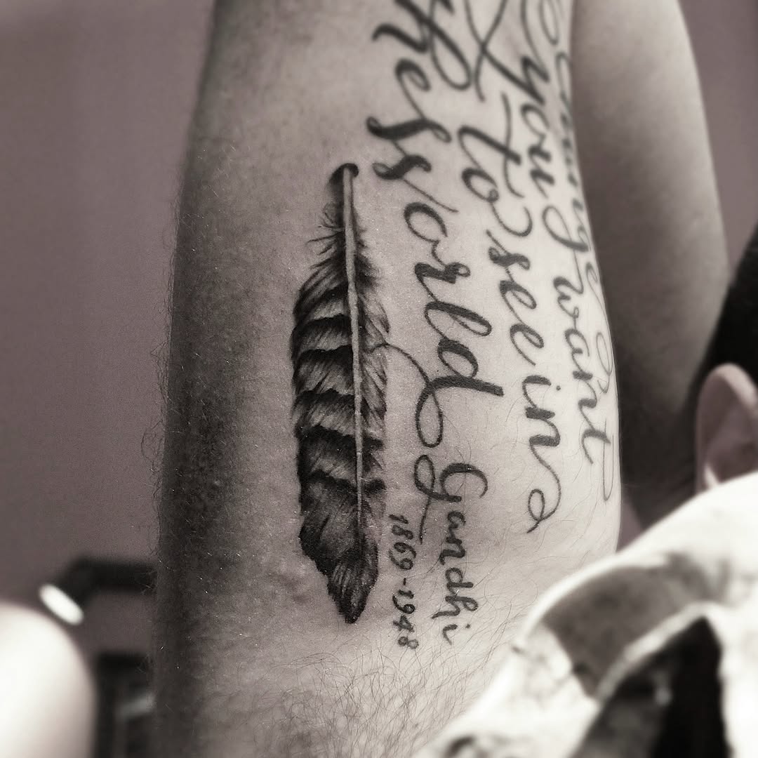 Feather and quote lettering tattoo on the forearm by Yana Aizen