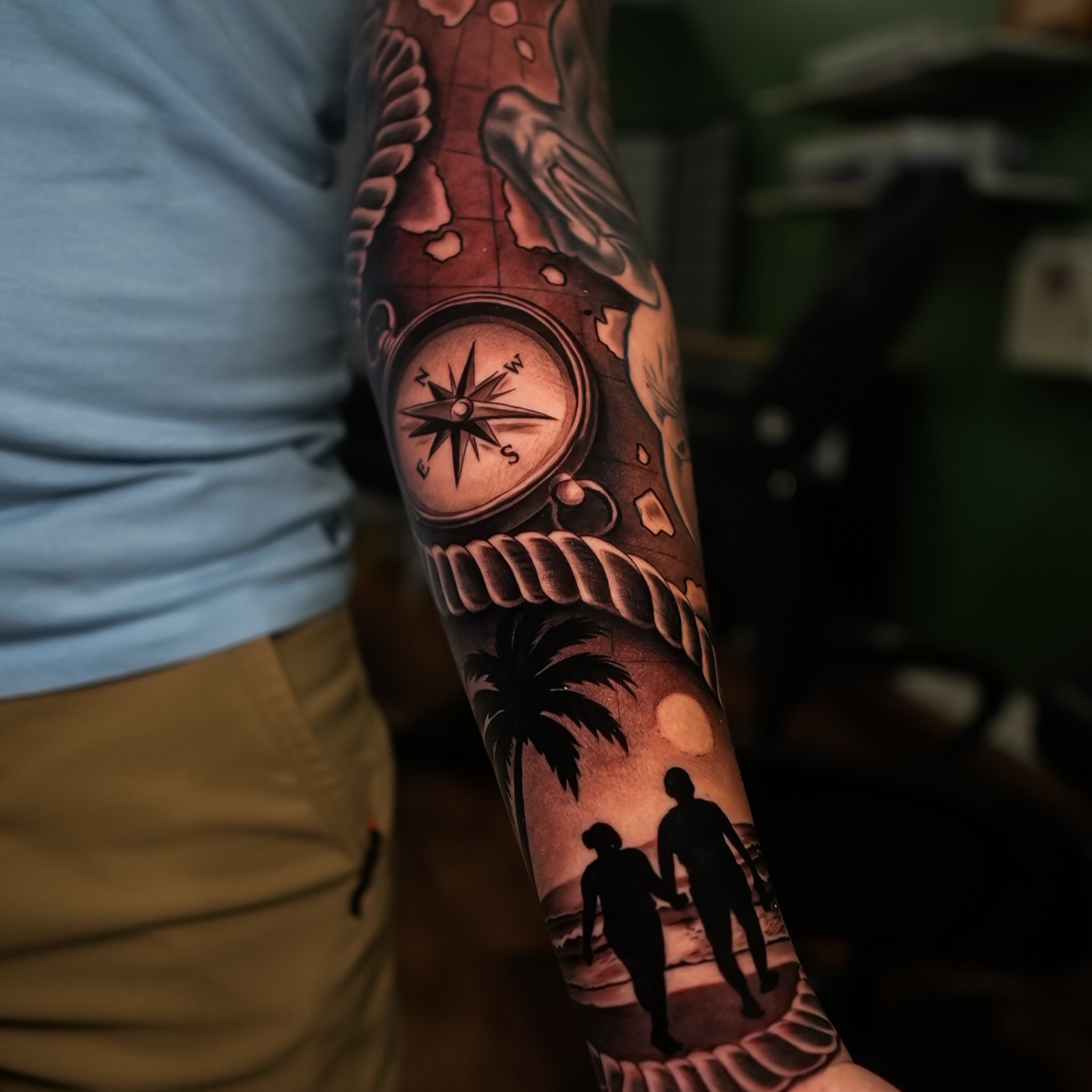 Compass and couple realism tattoo on the forearm by Javier Chavez