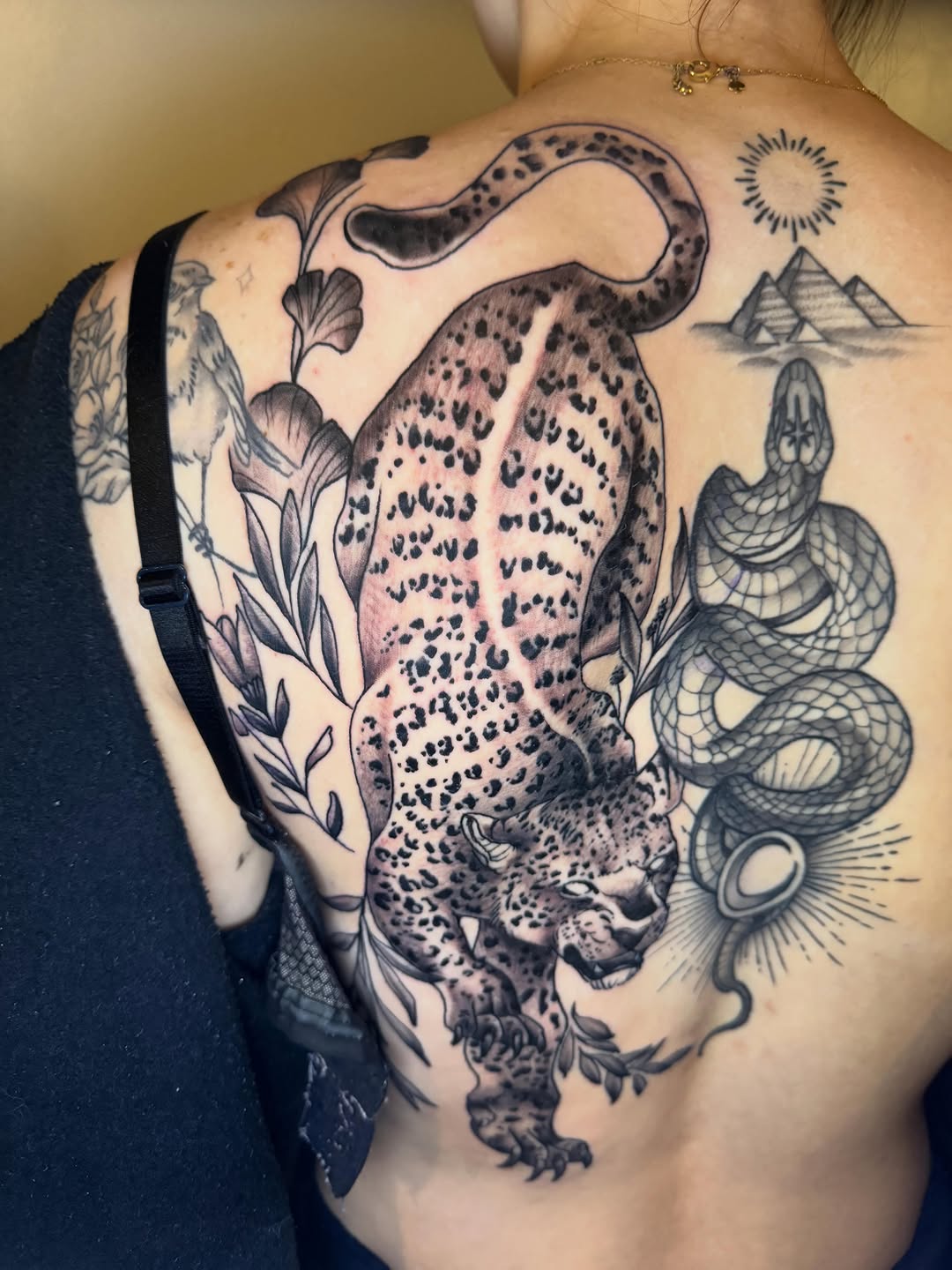Leopard and snake with Egyptian pyramids realism tattoo on the back by Mike Bean, Minneapolis, Minnesota