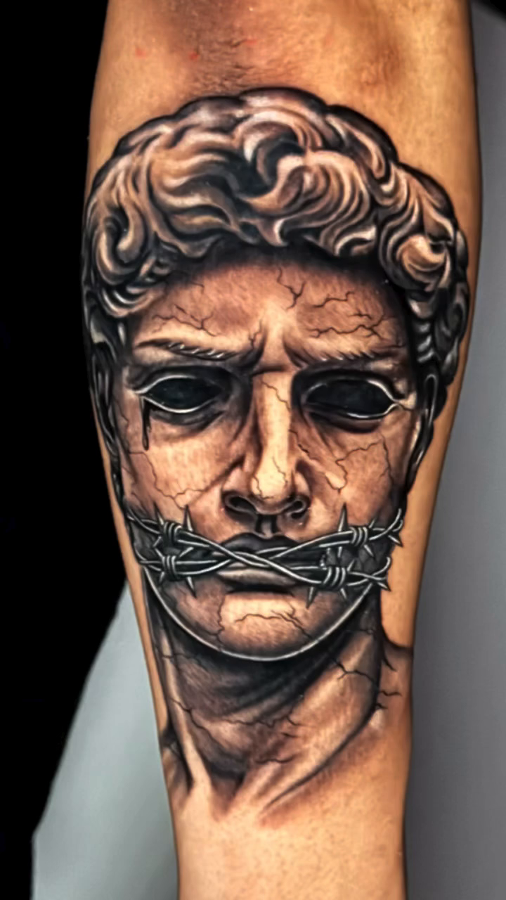 Bust of a man and barbed wire realism tattoo by professional tattoo artist