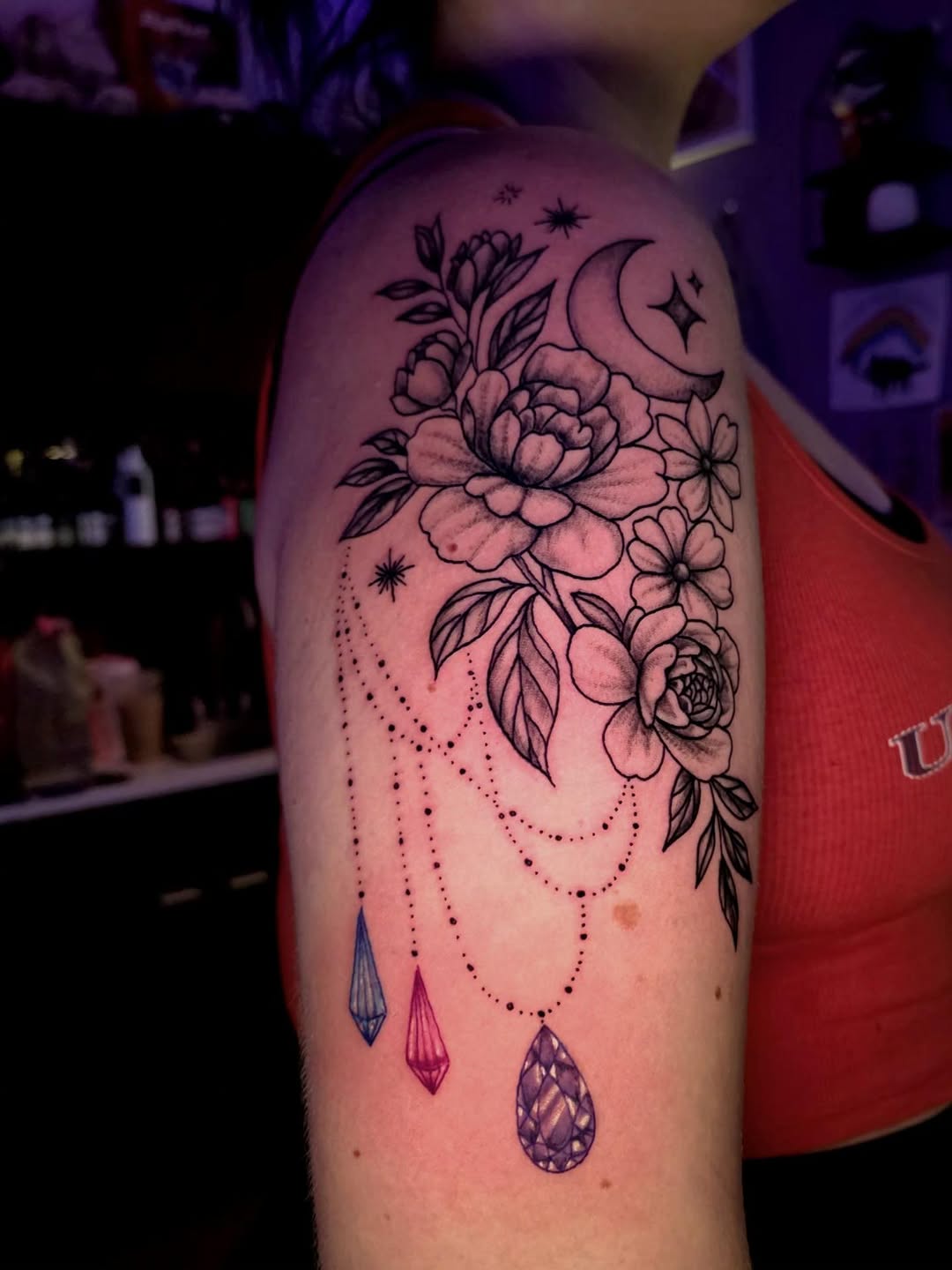 Flowers, moon, and crystals ornamental tattoo on the forearm by Karley Michelle Moody