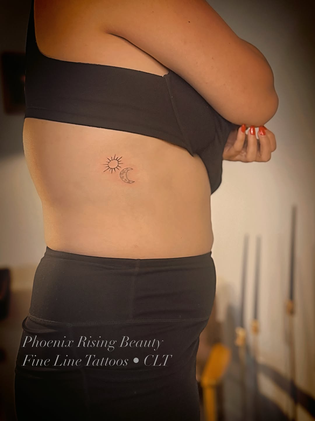 Sun and moon minimalist tattoo on the torso by Meagan, Charlotte, North Carolina
