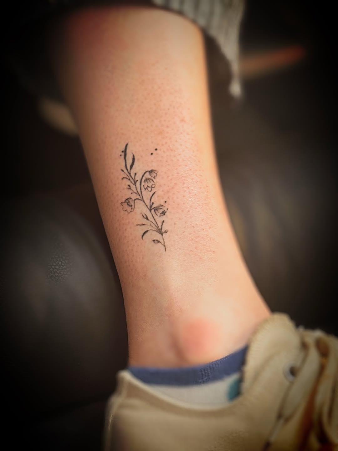 Lily of the valley sprig fine line tattoo on the forearm by Meagan, Charlotte, North Carolina