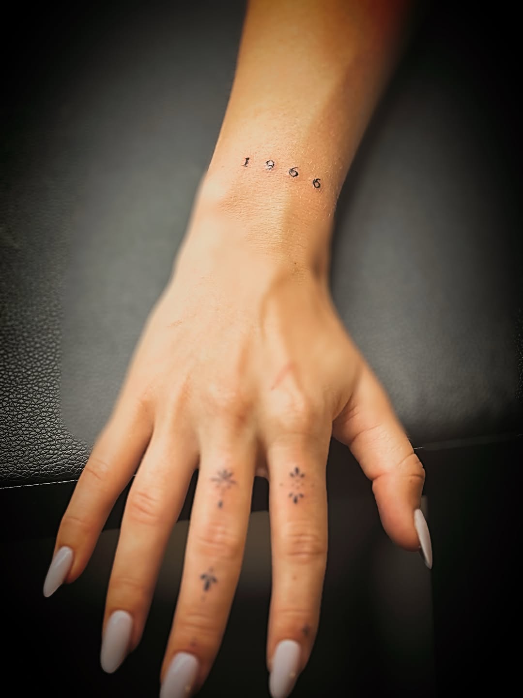 Numbers and small floral designs minimalist tattoo by Meagan, Charlotte, North Carolina