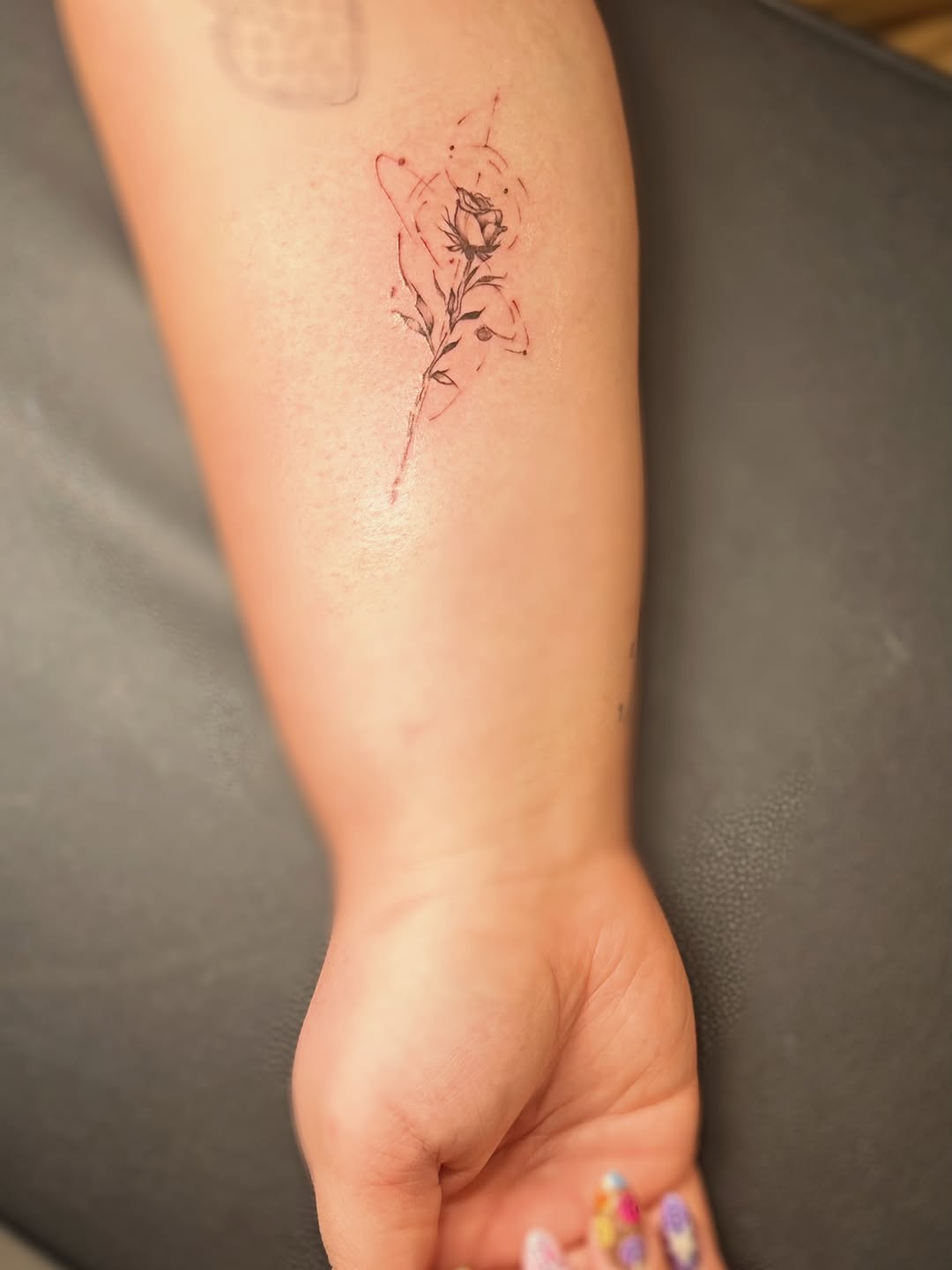 Rose with abstract elements watercolor tattoo on the forearm by Meagan, Charlotte, North Carolina