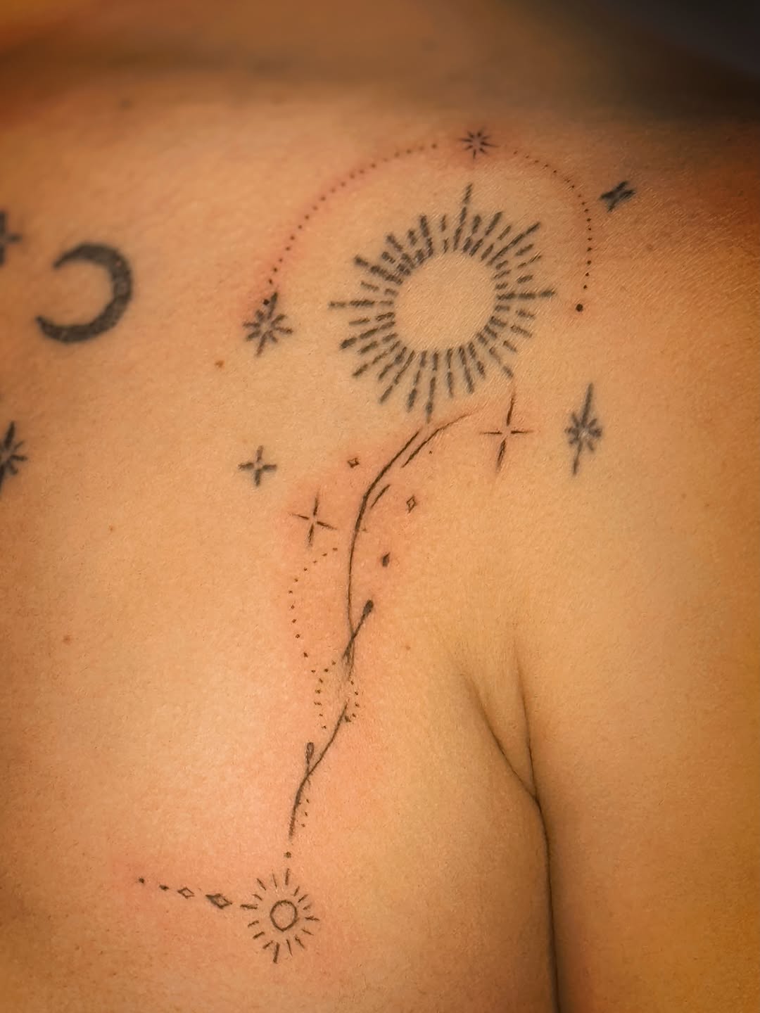 Celestial elements with sun and moon ornamental tattoo on the shoulder by Meagan, Charlotte, North Carolina