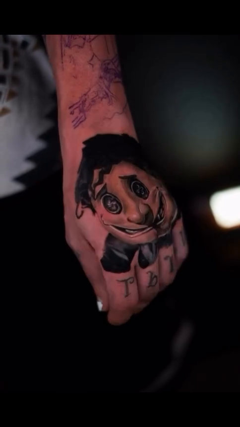 Creepy doll face on hand realism tattoo on the hand by @inkedbystabby, Manchester, New Hampshire