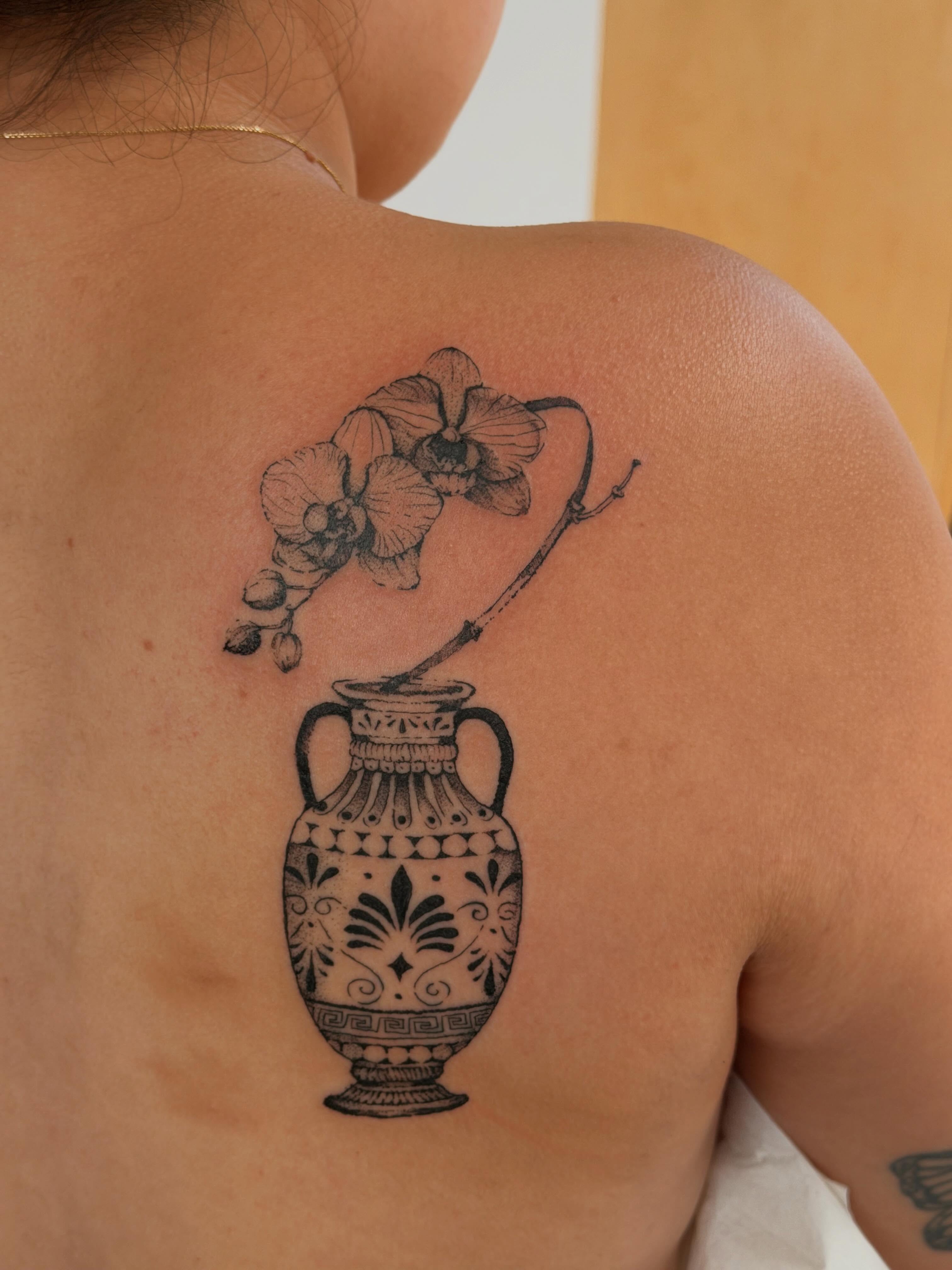 Vase with orchid black and grey tattoo on the back by Babymaxy Inks Llc