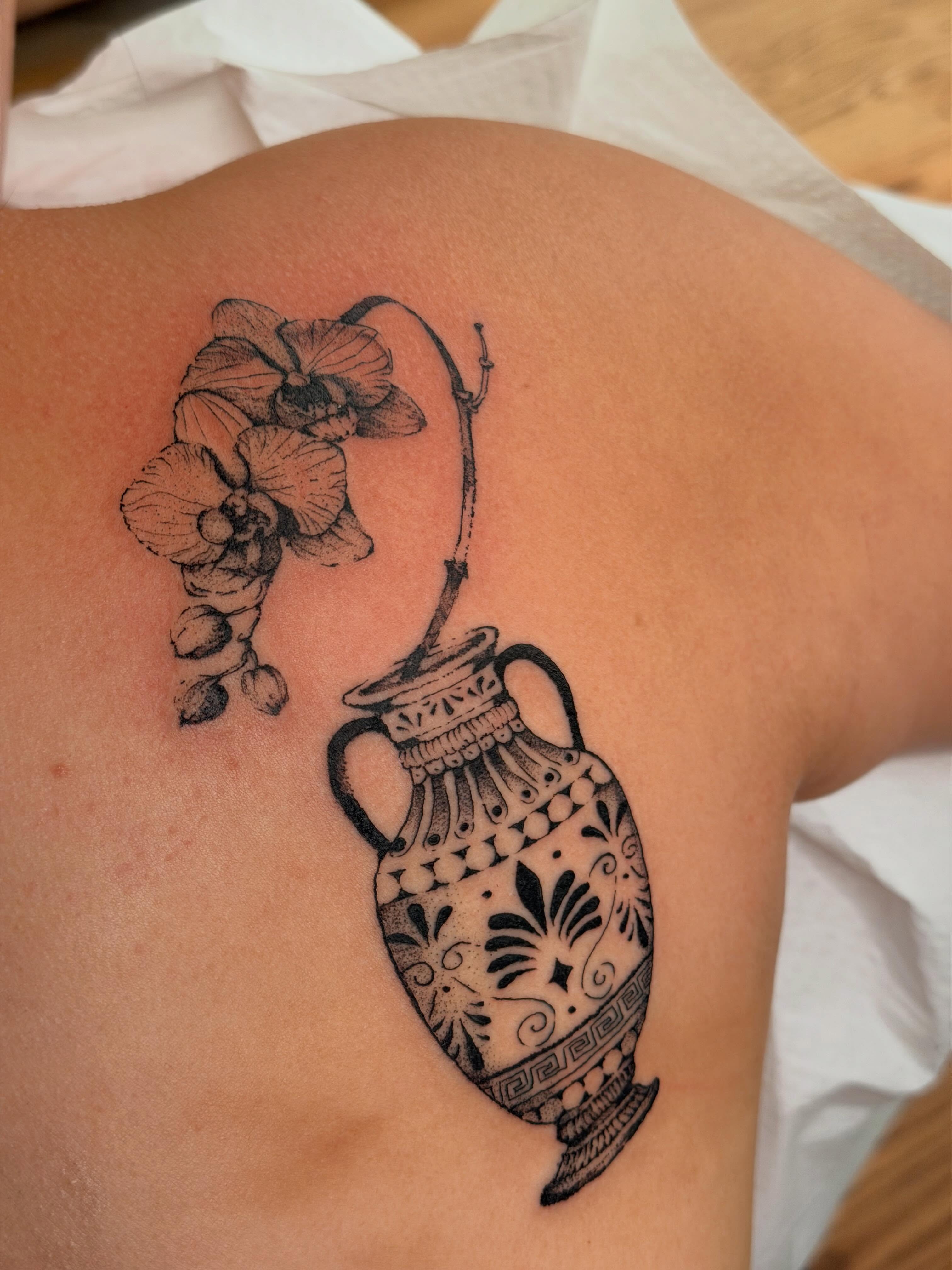 Vase with orchid black and grey tattoo on the back by Babymaxy Inks Llc