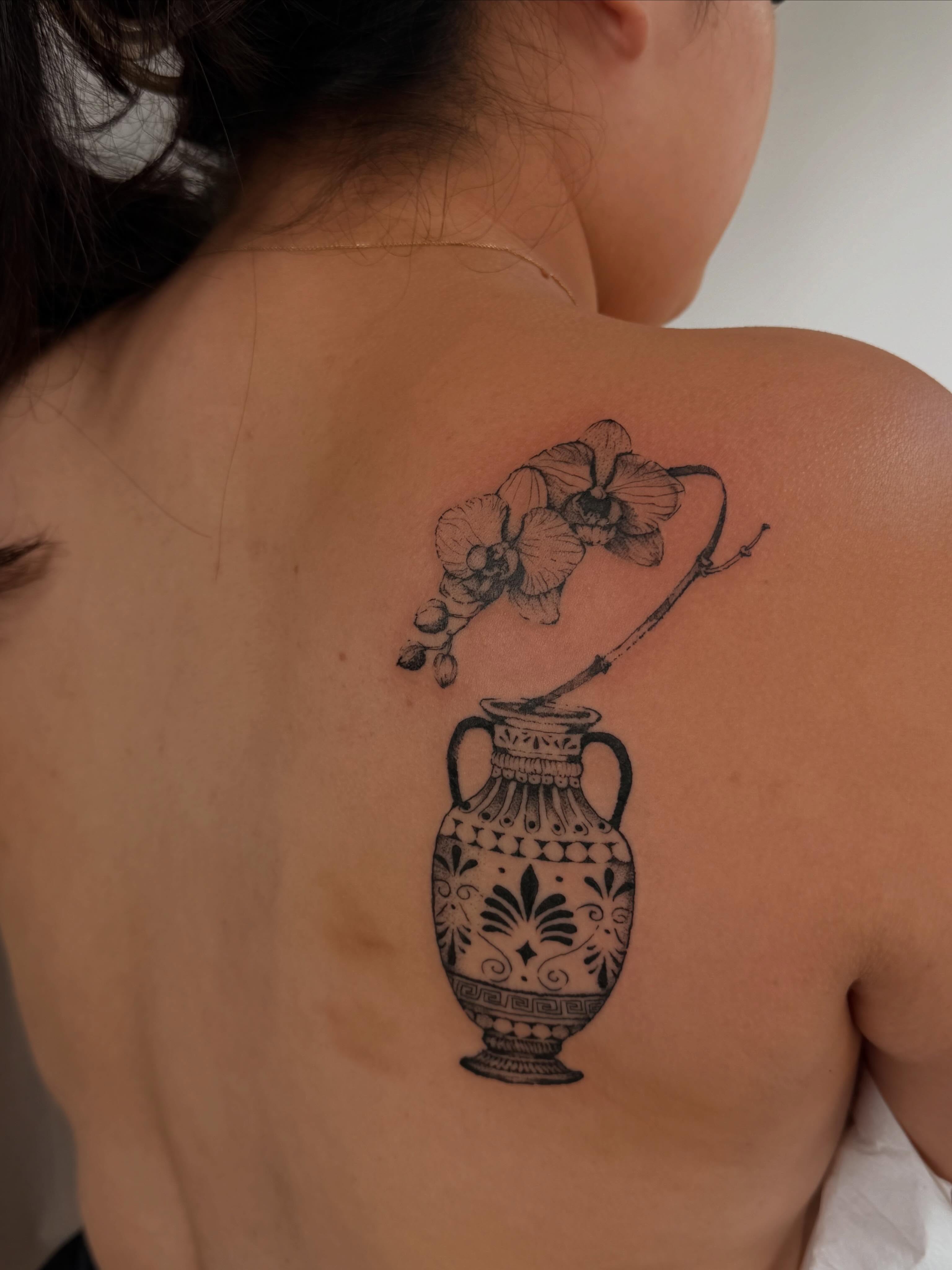Vase with orchid black and grey tattoo on the back by Babymaxy Inks Llc