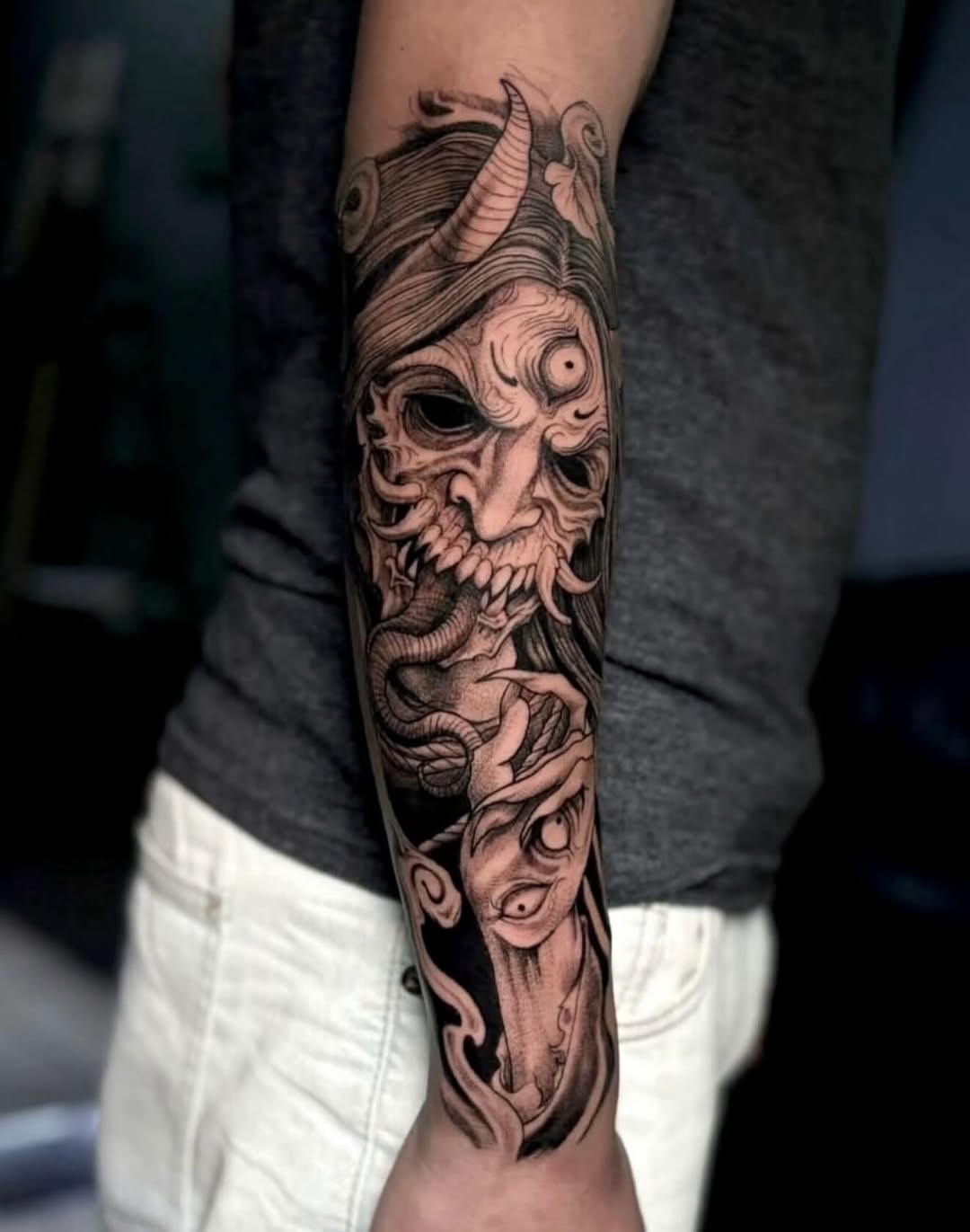 Demonic mask with snake Japanese tattoo on the forearm by @elijahtats