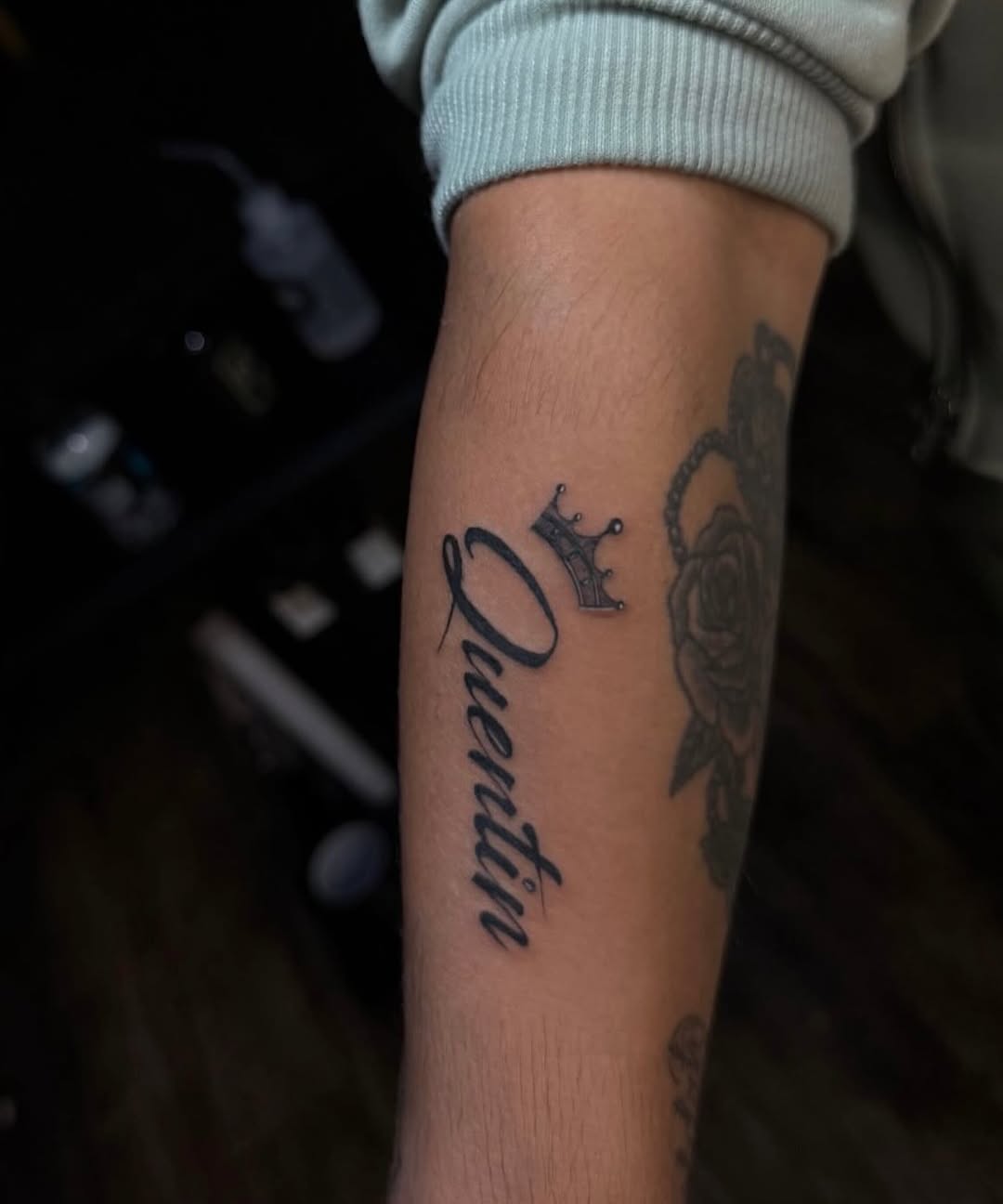 Name with crown lettering tattoo on the forearm by @elijahtats