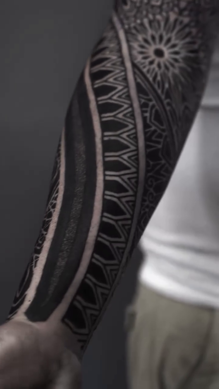 Full sleeve geometric blackwork tattoo tribal tattoo on the upper arm by Oliver kenton, San Diego, California