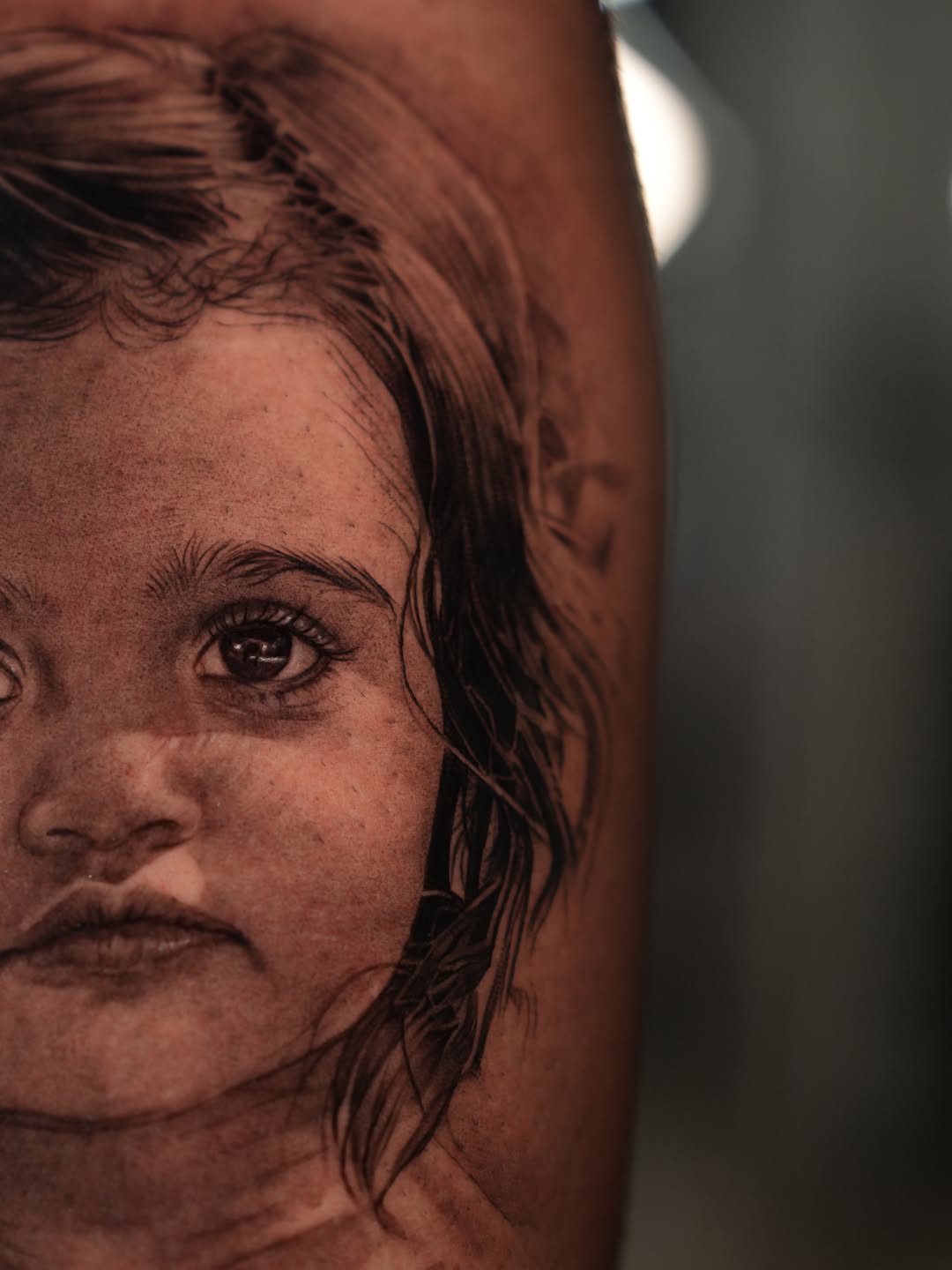 Portrait of a child realism tattoo on the forearm by J O S S I e L P I N e D A