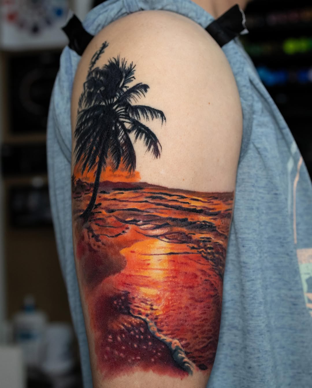 Beach sunset with palm tree fine line tattoo on the upper arm by Realistic tattoos in Minneapolis, MN, Minneapolis, Minnesota