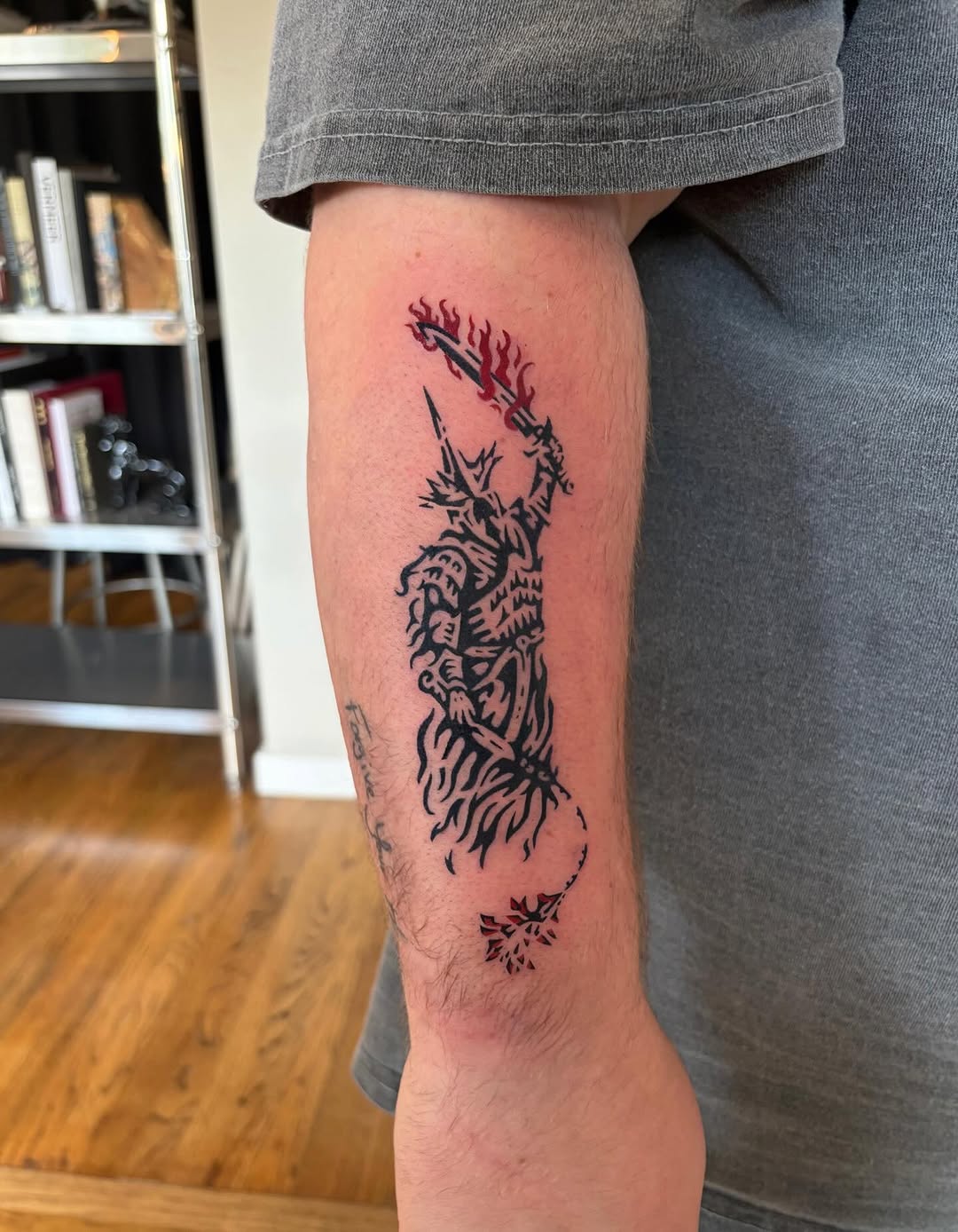 Armored figure with flaming sword blackwork tattoo on the forearm by M