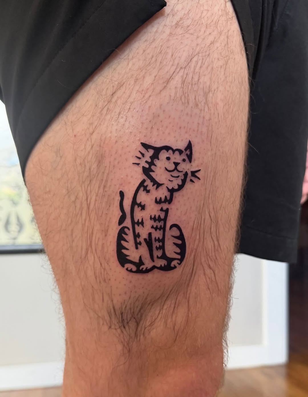 Stylized cat realism tattoo on the thigh by M