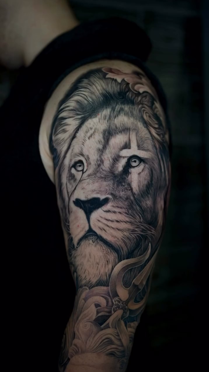 Lion portrait with ornamental elements realism tattoo on the forearm by Ink Warden  Tattoo