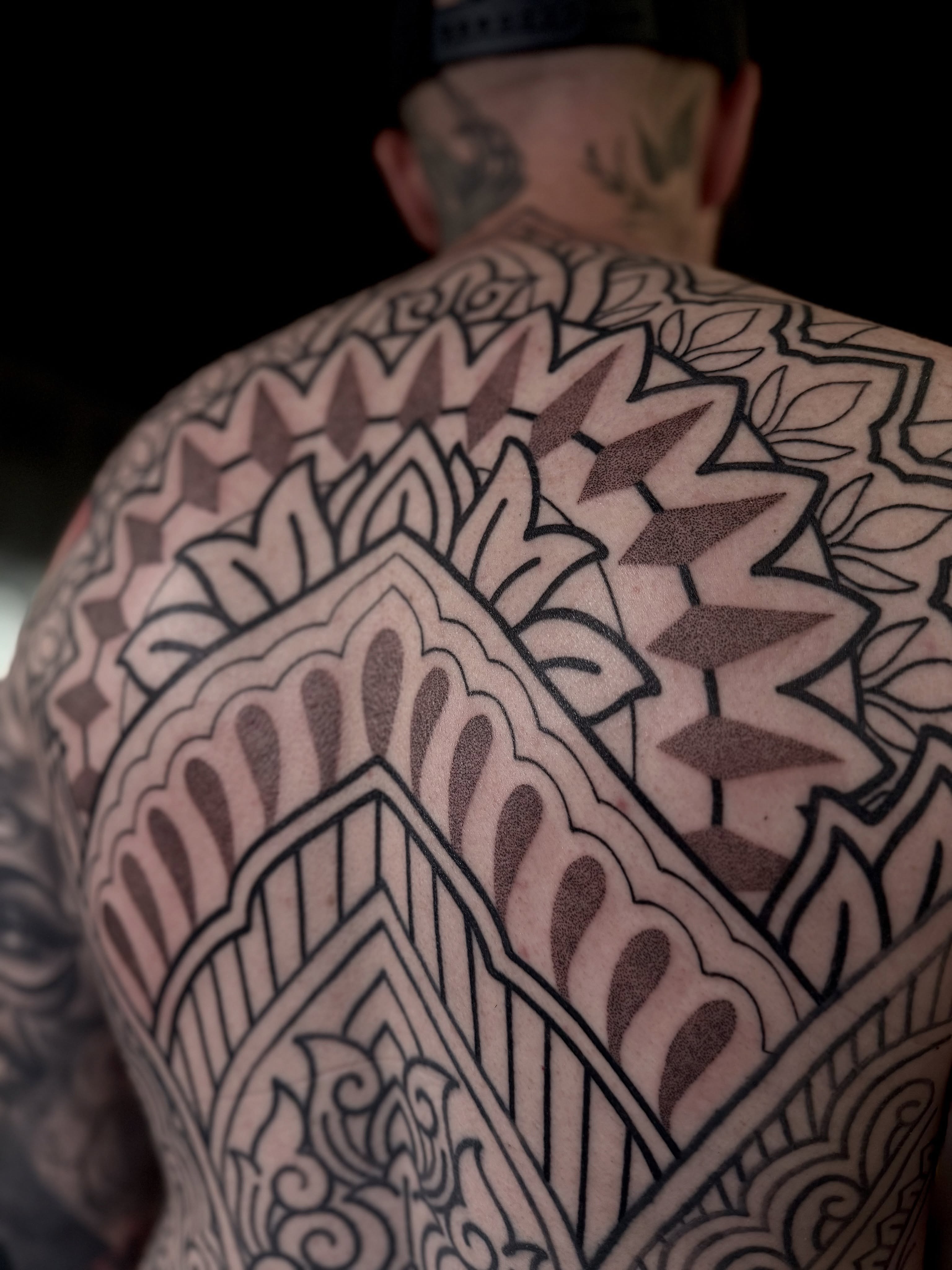 Geometric pattern geometric tattoo on the back by Haley Corinne