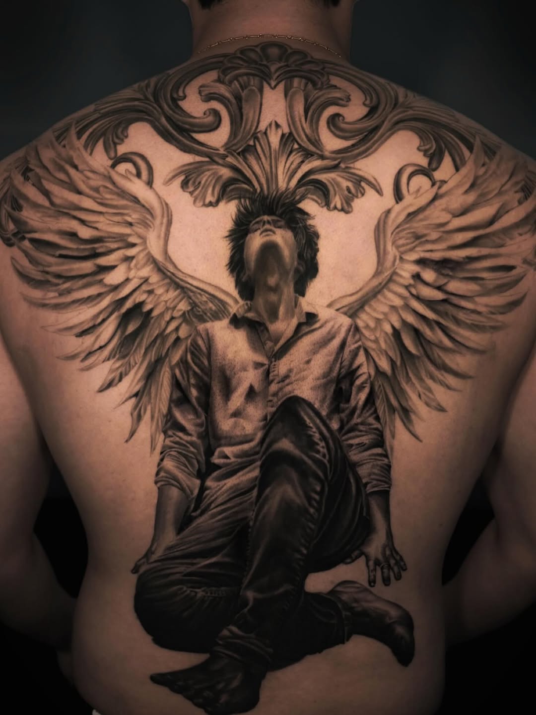 Angelic figure with wings realism tattoo on the back by Pitasso tattoo black and grey