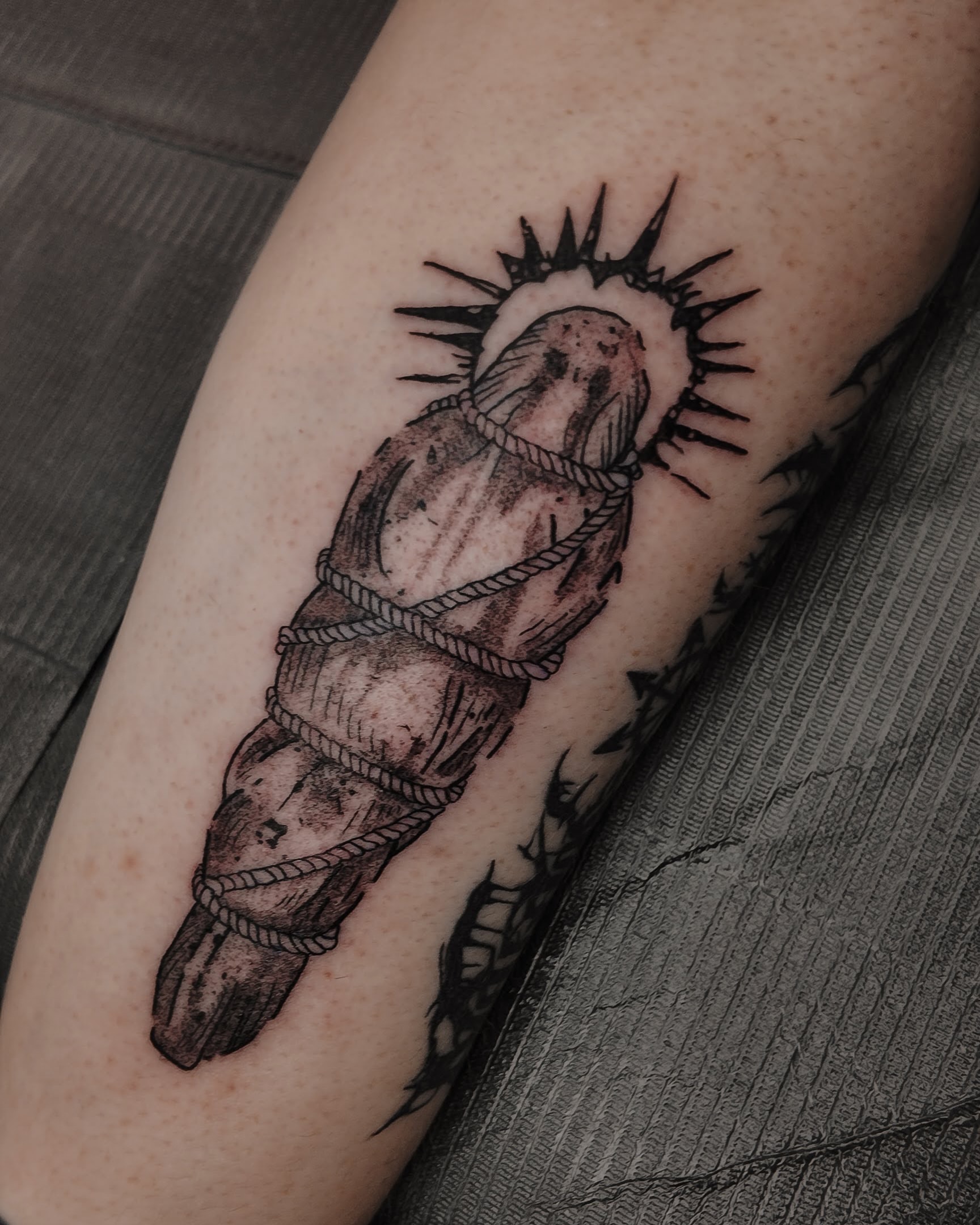 Bound figure black and grey tattoo on the forearm by Morgan Diann