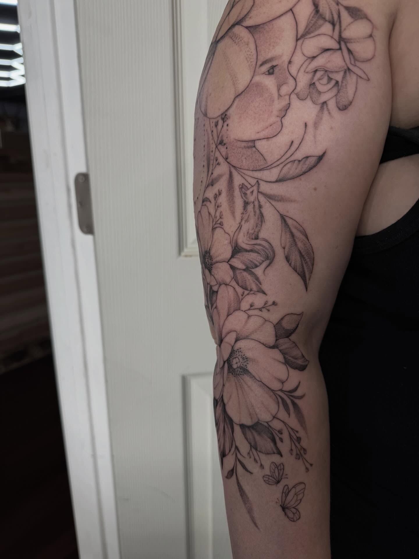 Mother and child with flowers realism tattoo on the forearm by Emma Mathis, Springfield, Oregon