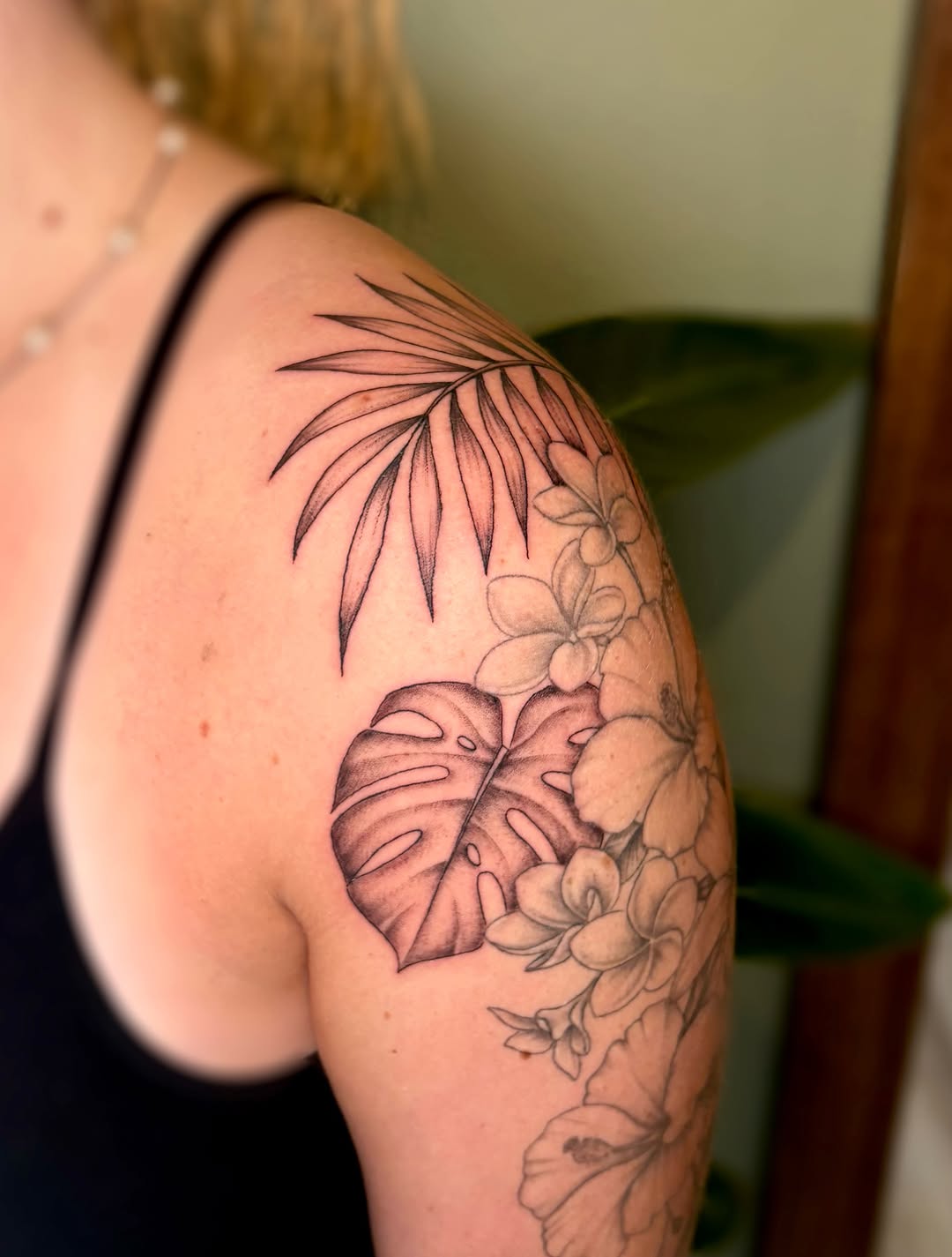 Tropical leaves and flowers tribal tattoo on the shoulder by Bianca Cattapan