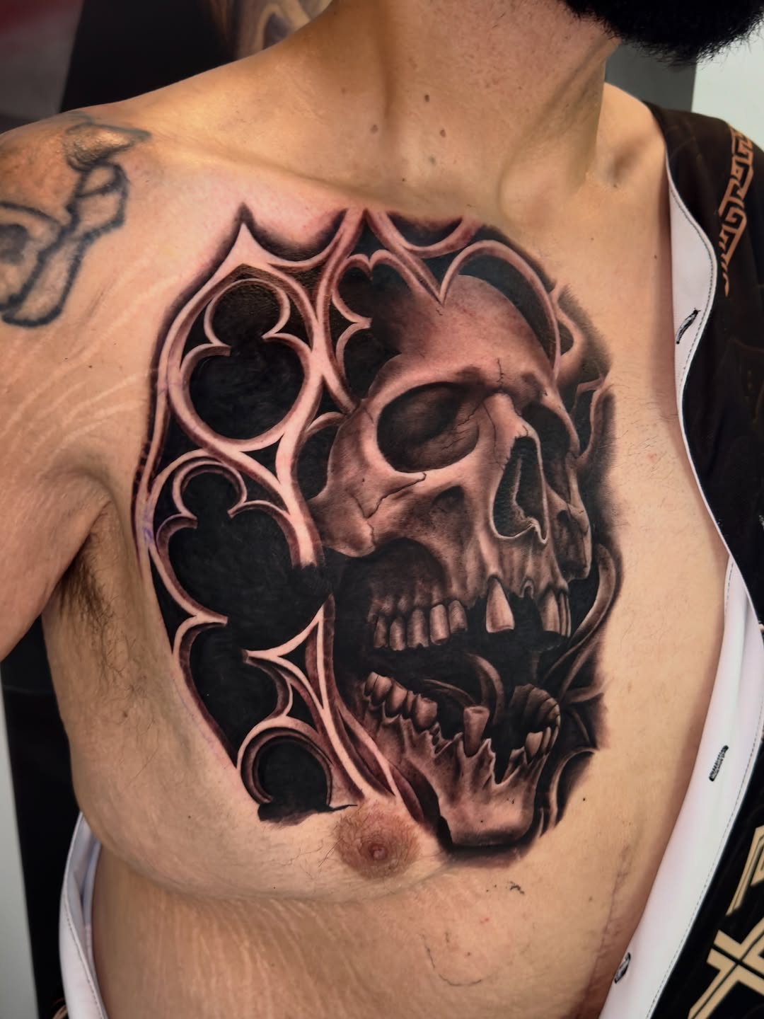 Skull with gothic frame realism tattoo on the chest by Brandon Patino