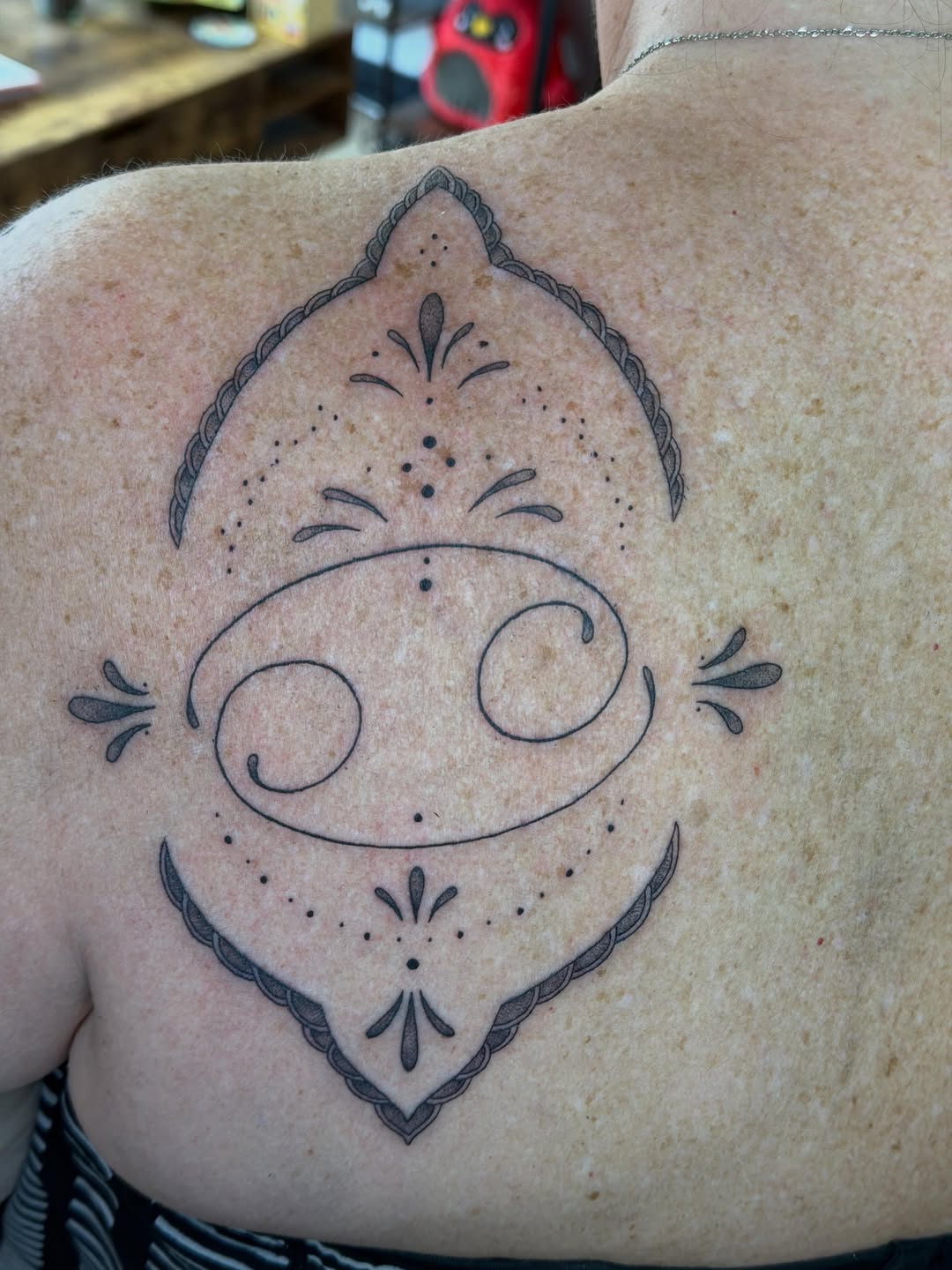 Cancer zodiac symbol with ornamental details tribal tattoo on the shoulder by Stvn Geyer, Urbandale, Iowa