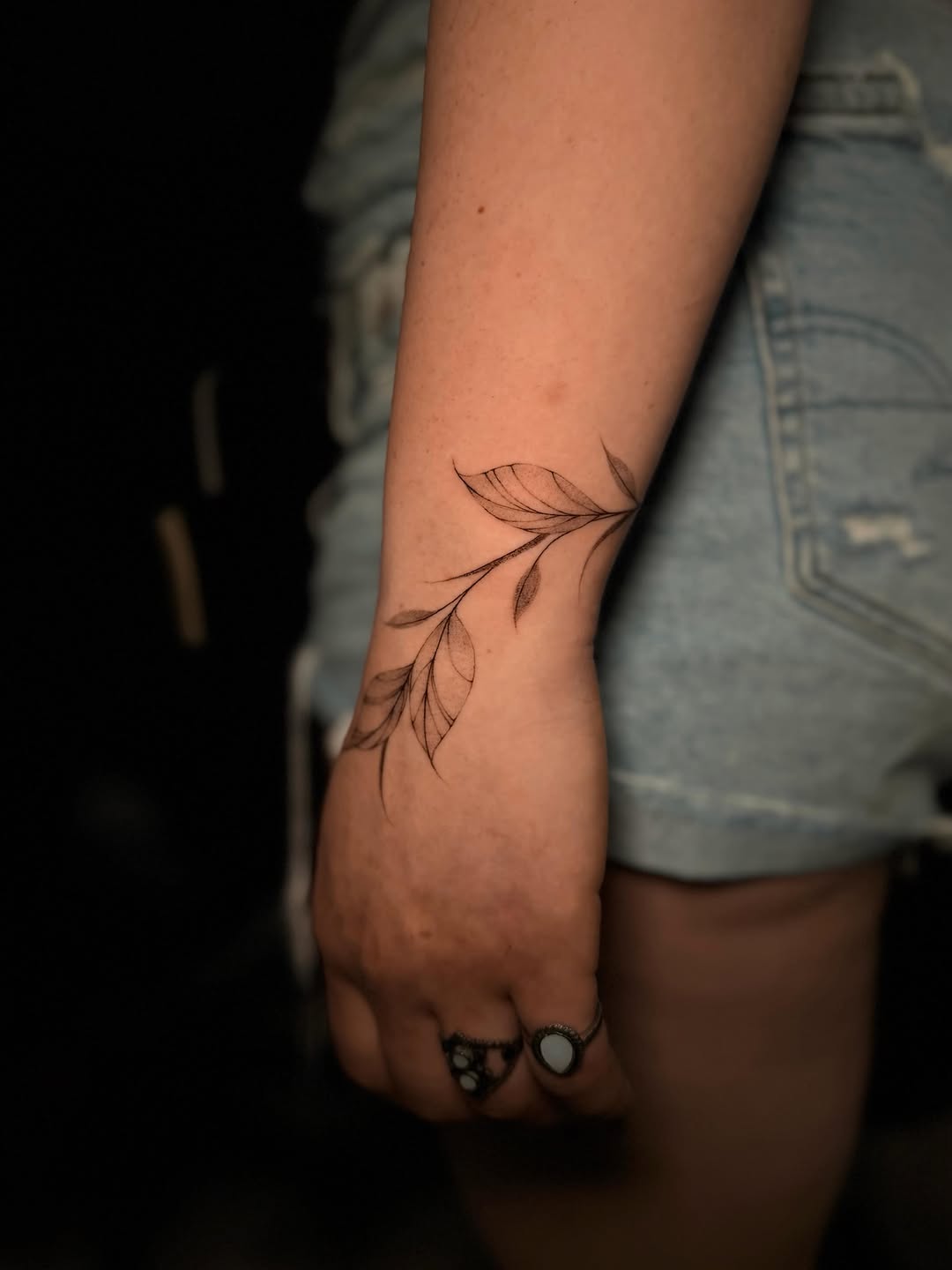 Branch with leaves fine line tattoo on the forearm by Frida Tattooista