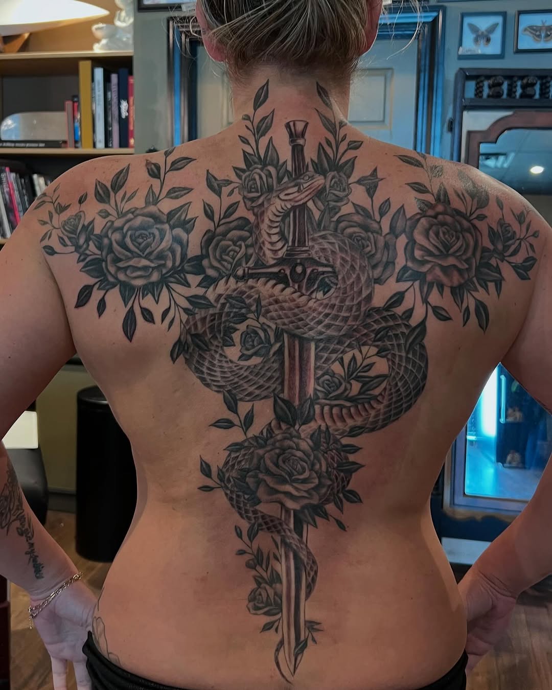 Snake and sword with roses tribal tattoo on the back by Jesse Gray