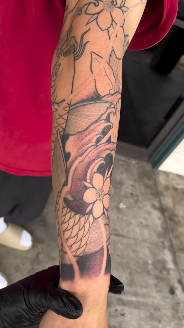 Hannya mask and koi fish sleeve Japanese tattoo on the upper arm by Derek (Nghia) Chung