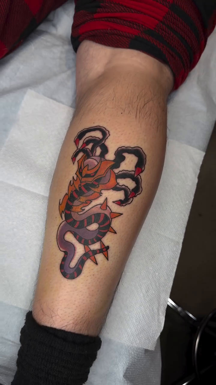 Tiger with claws American traditional tattoo on the forearm by Mercy Dean